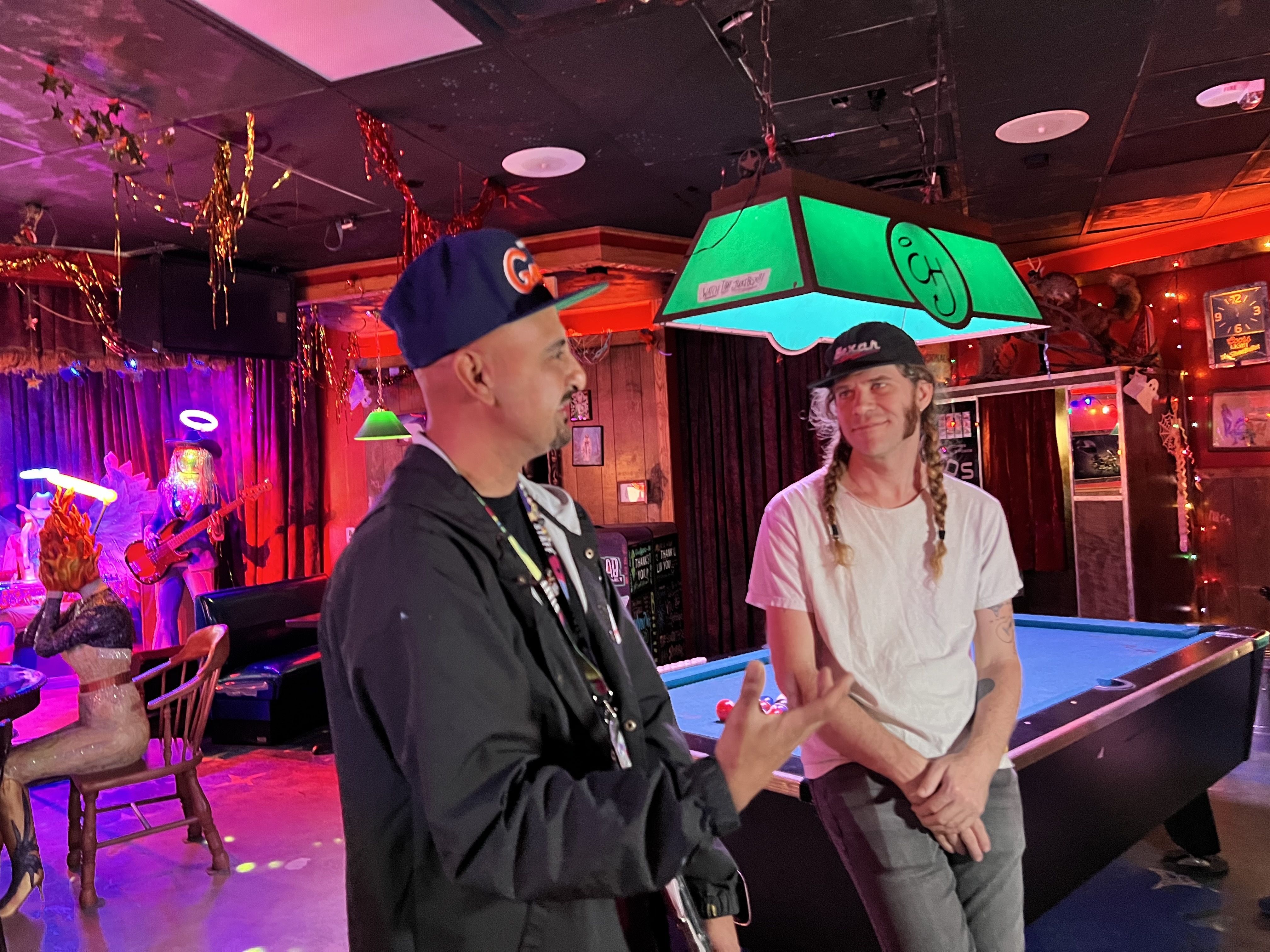 Photo of two artists in a dive bar
