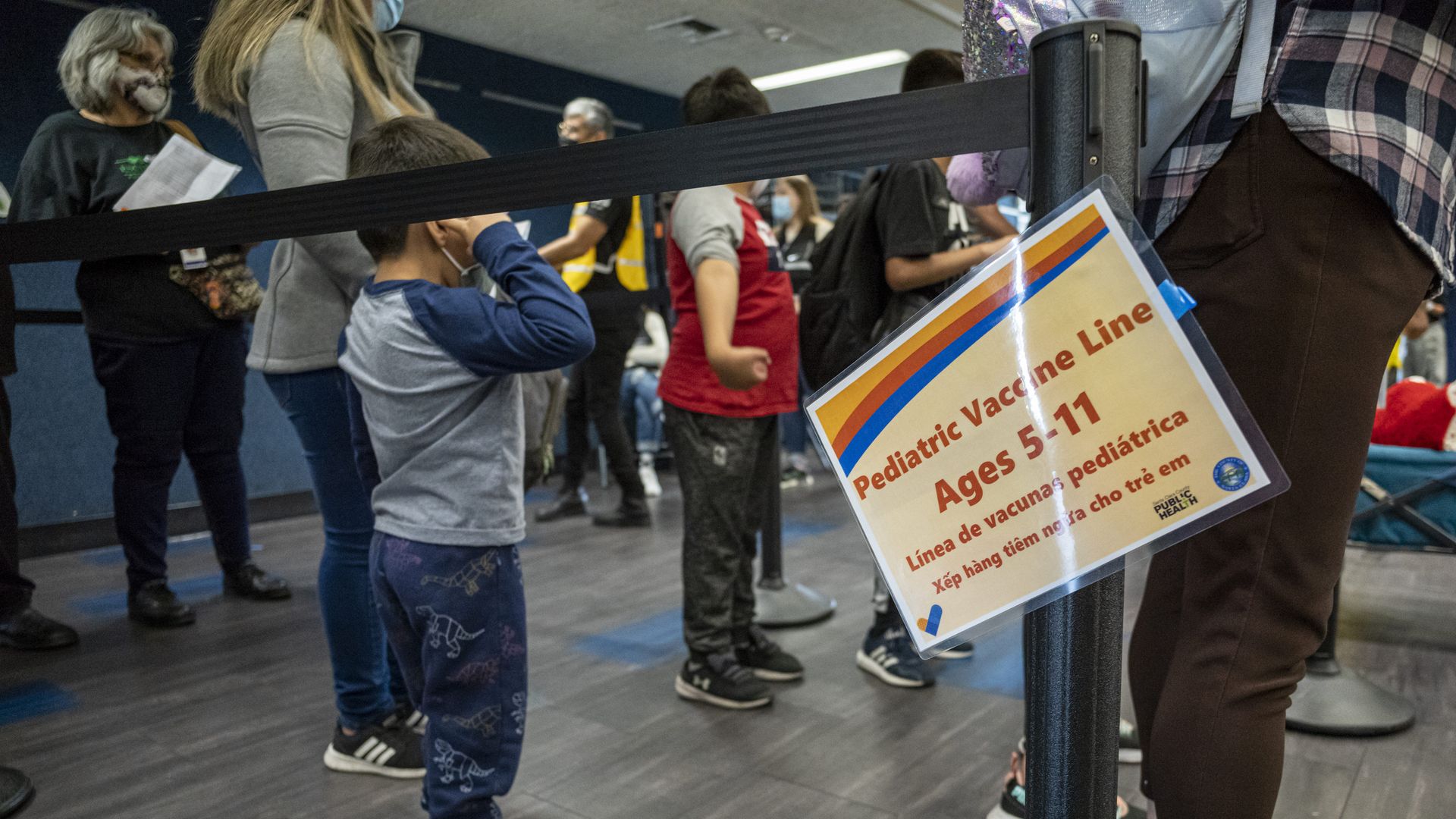 Children wait in line to receive a dose of the Pfizer-BioNTech Covid-19 vaccine at a vaccination clinic at an elementary school in San Jose, California.