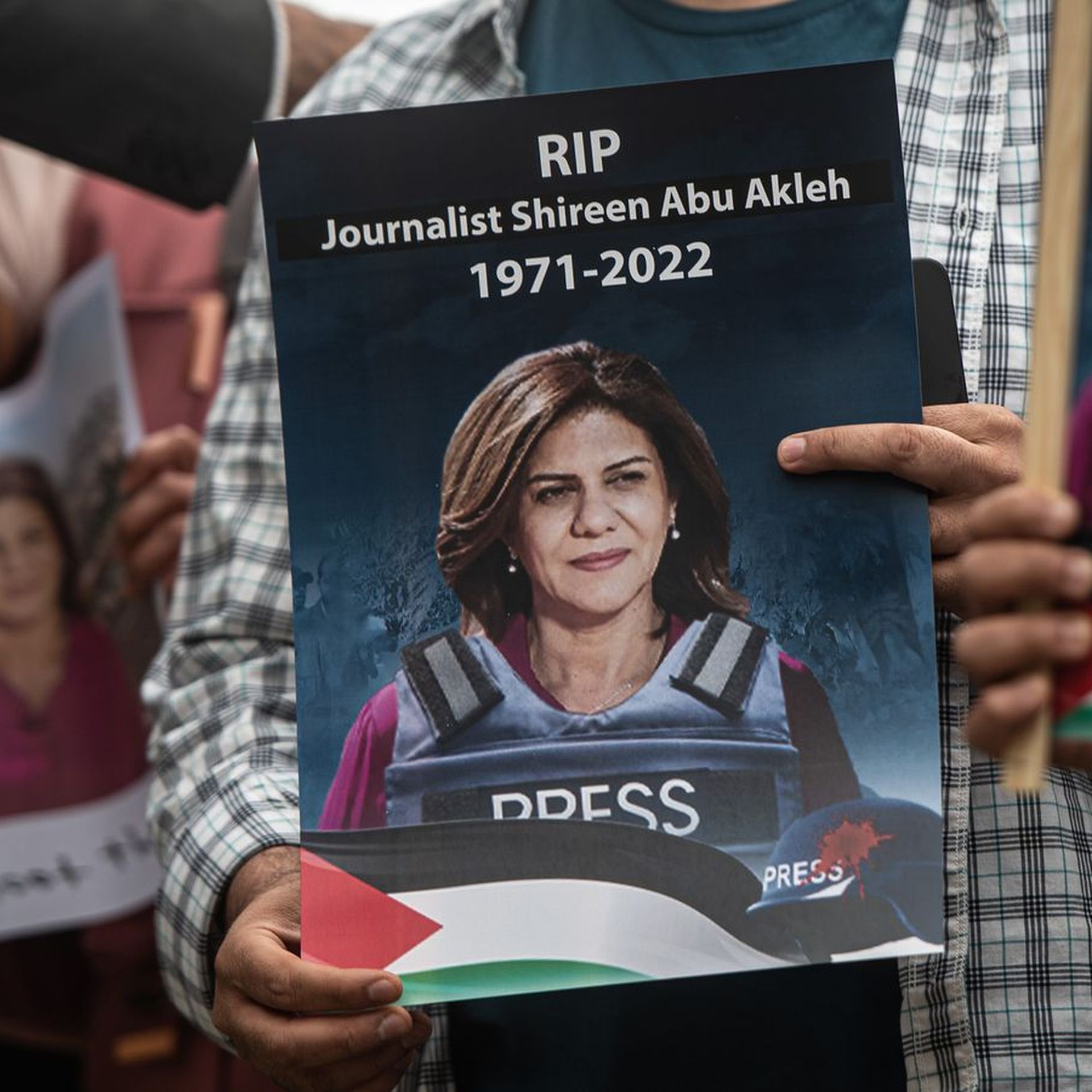 A person holds a sign with the picture of Shireen Abu Akleh at a protest in London on May 12. Photo: Guy Smallman/Getty Images