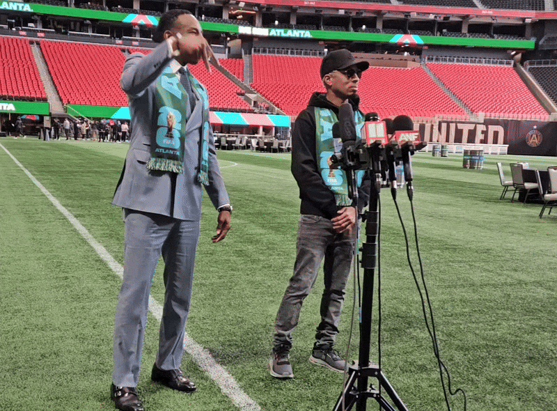 Mayor Andre Dickens, left, and Atlanta songwriter and music producer Dallas Austin react to the city's new Sonic ID for the 2026 FIFA World Cup.