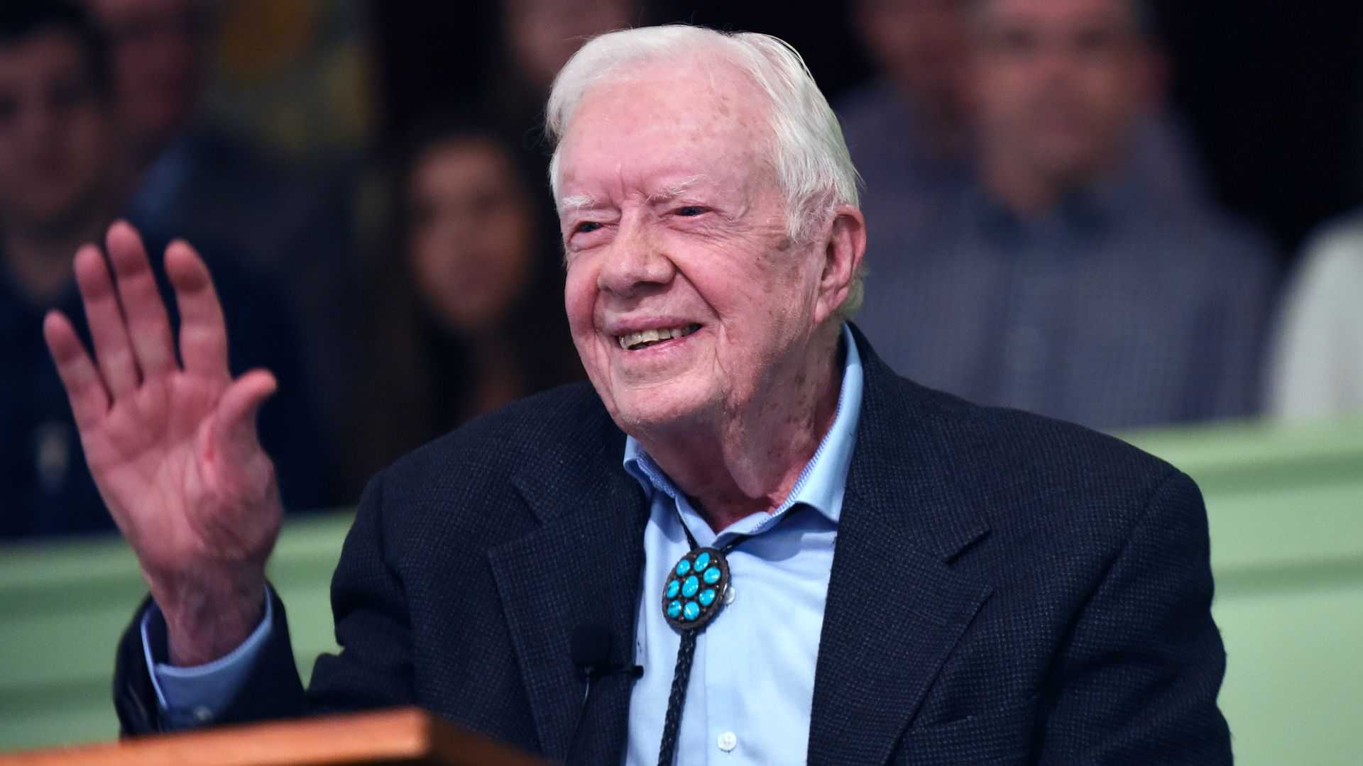 Jimmy Carter at his church waving to people.