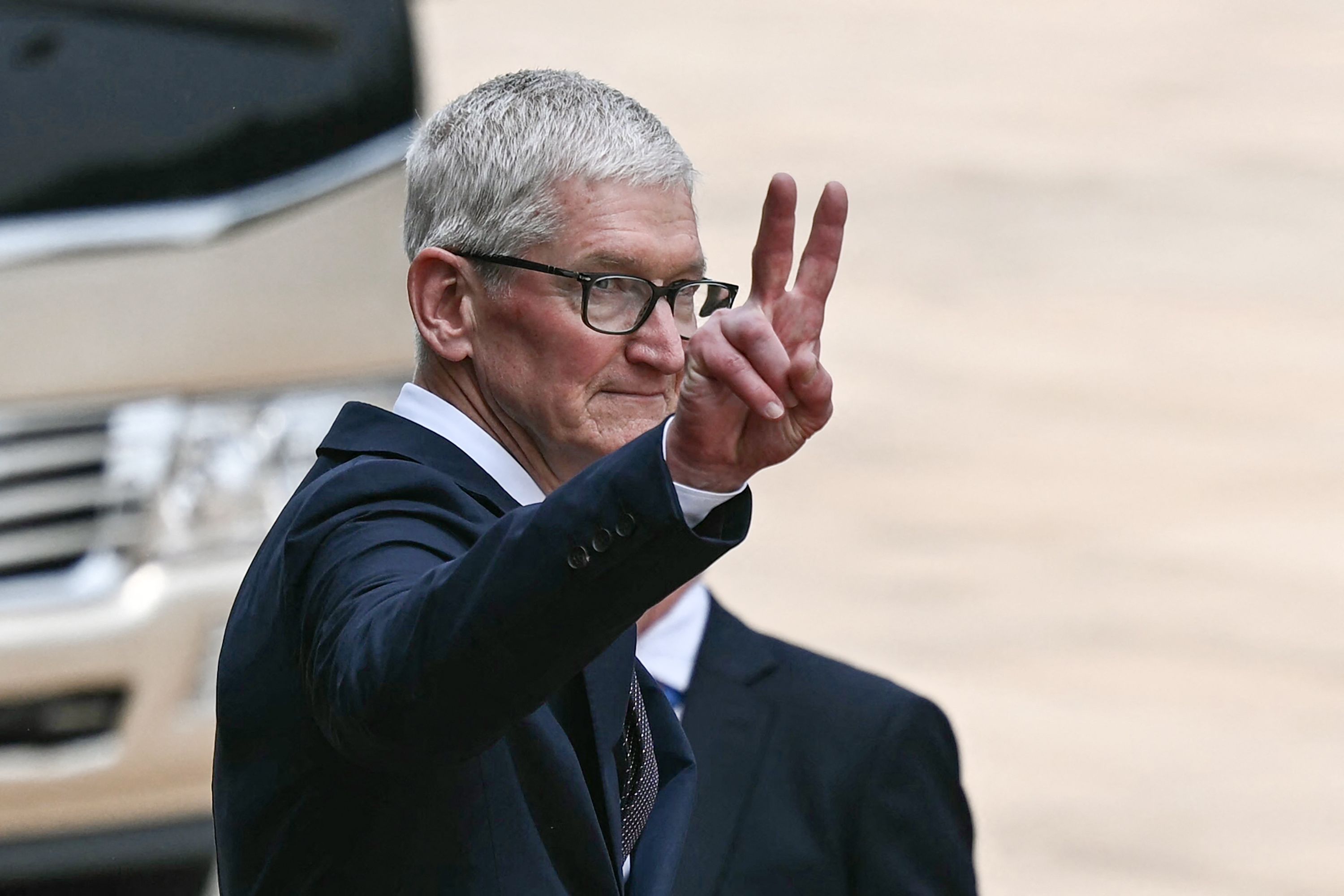 Apple CEO Tim Cook gestures after a welcome ceremony for US President Donald Trump at the Great Hall of the People in Beijing on May 14, 2026. (Photo by Brendan SMIALOWSKI / AFP via Getty Images)