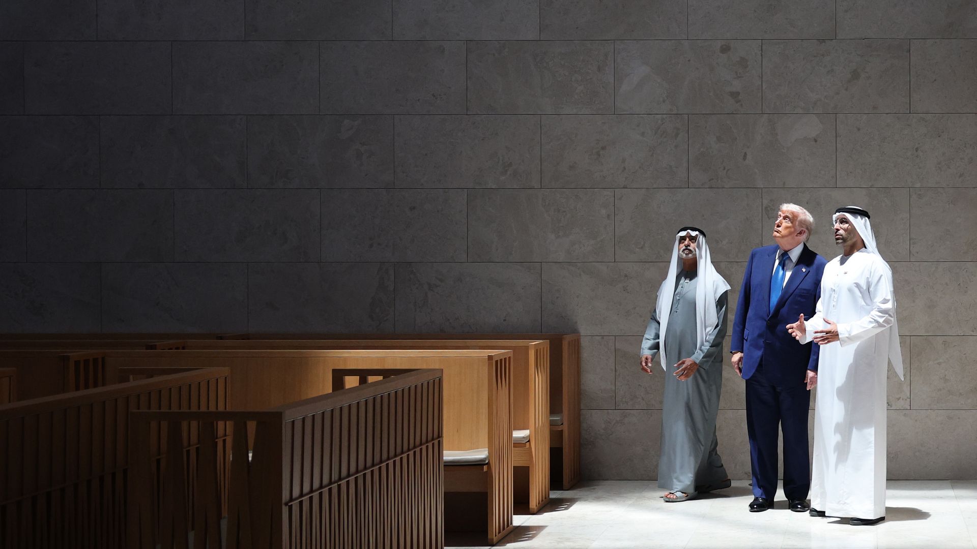 Trump looking up with two men