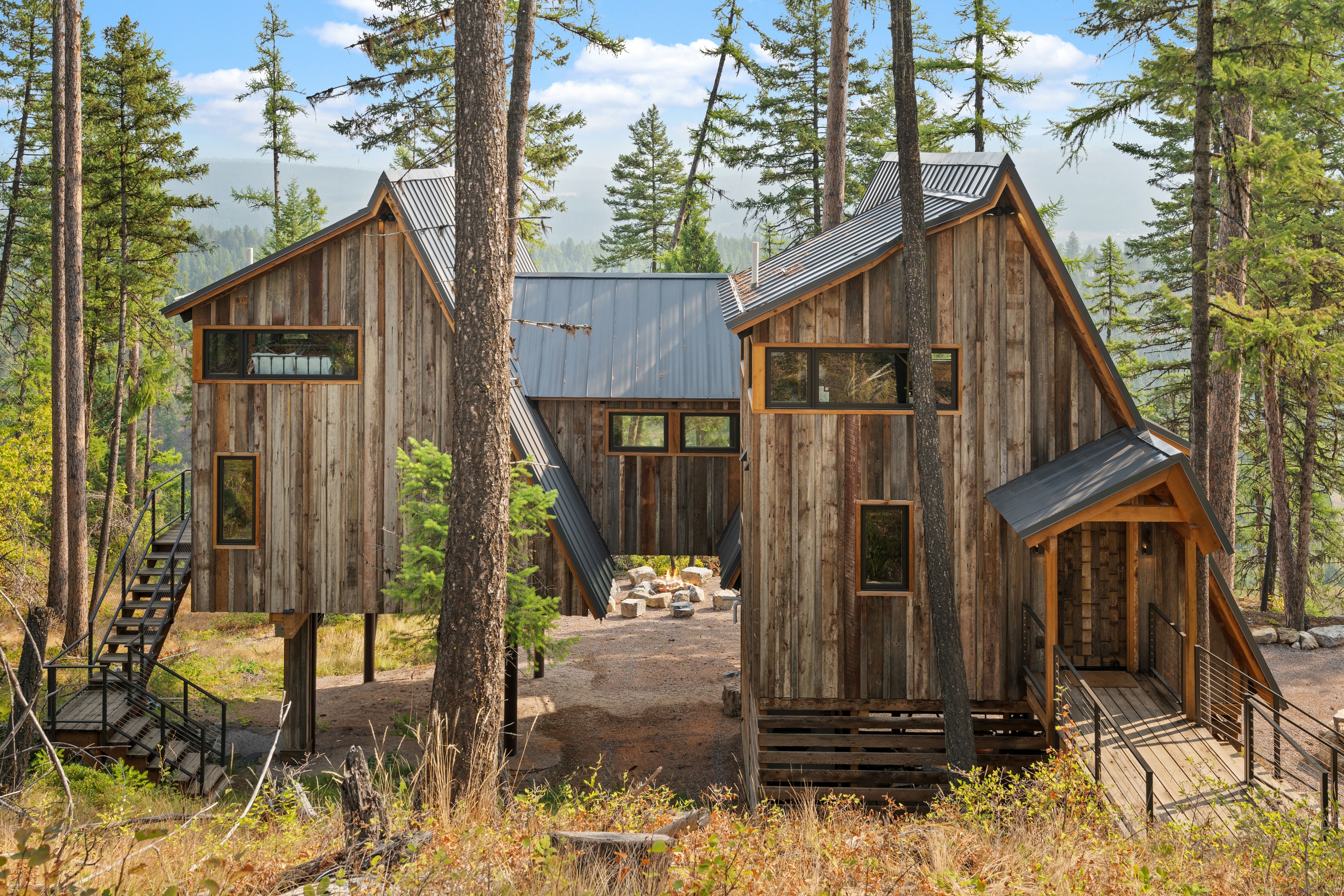 The back of an A-frame home shows lots of wood paneling.