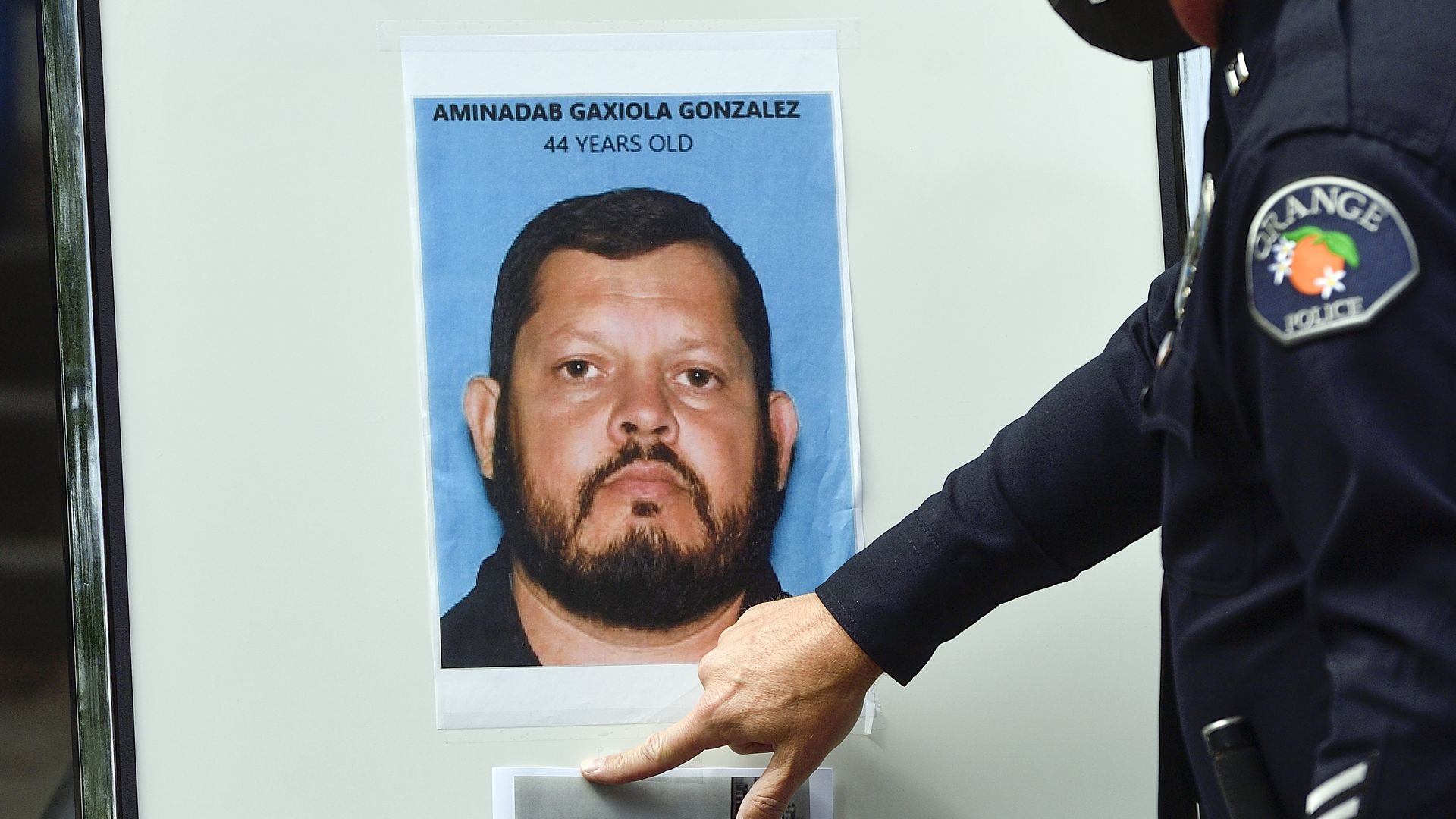 Orange Police Chief Dan Adams posts a picture of Aminadab Gaxiola Gonzalez during a press conference on April 1.