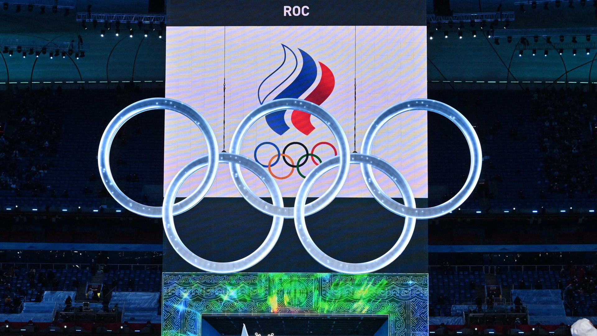 The delegation from Russia takes part in the parade of athletes, underneath the Olympics rings,