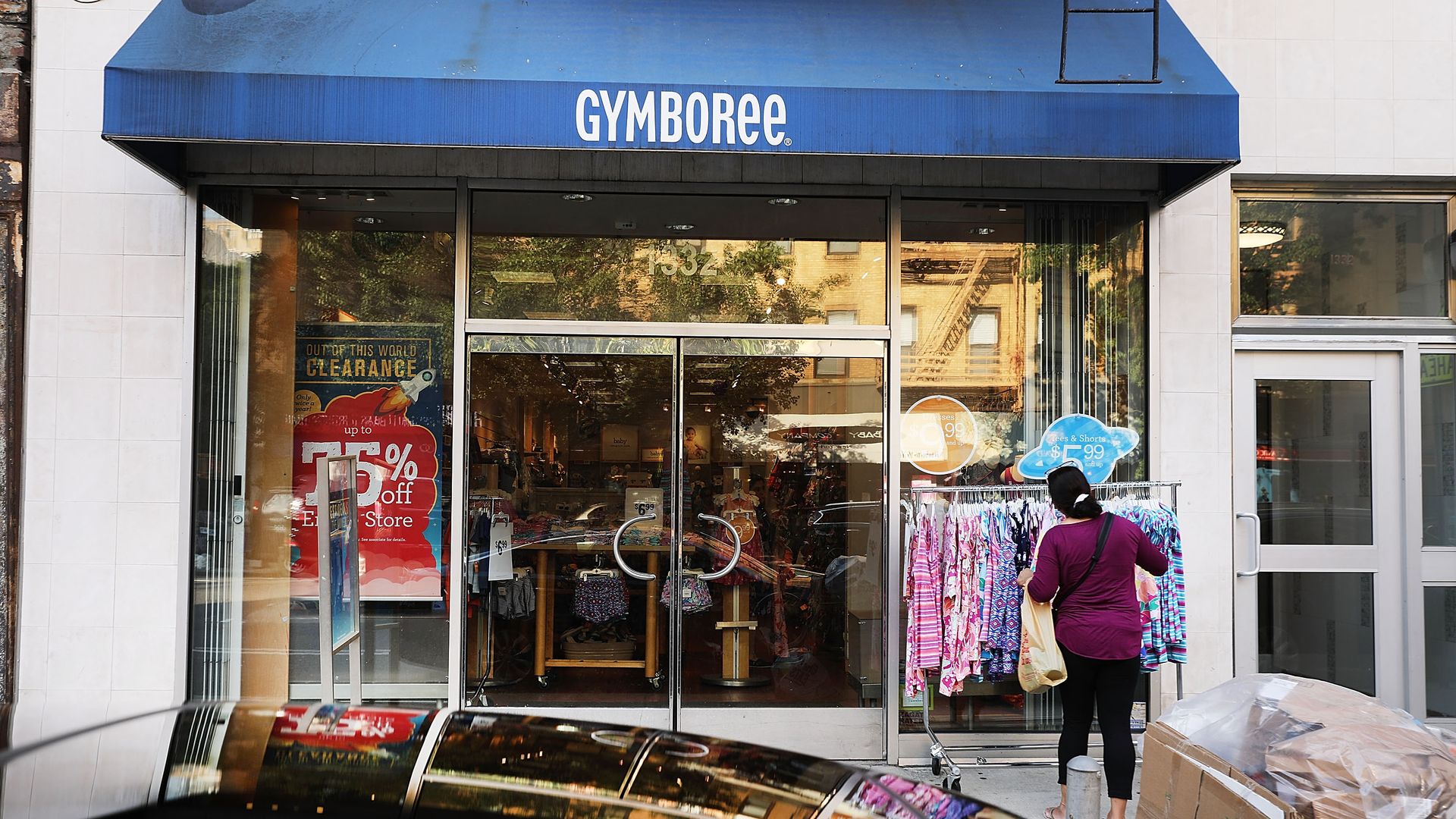 Racks of clothes outside a closing Gymboree store
