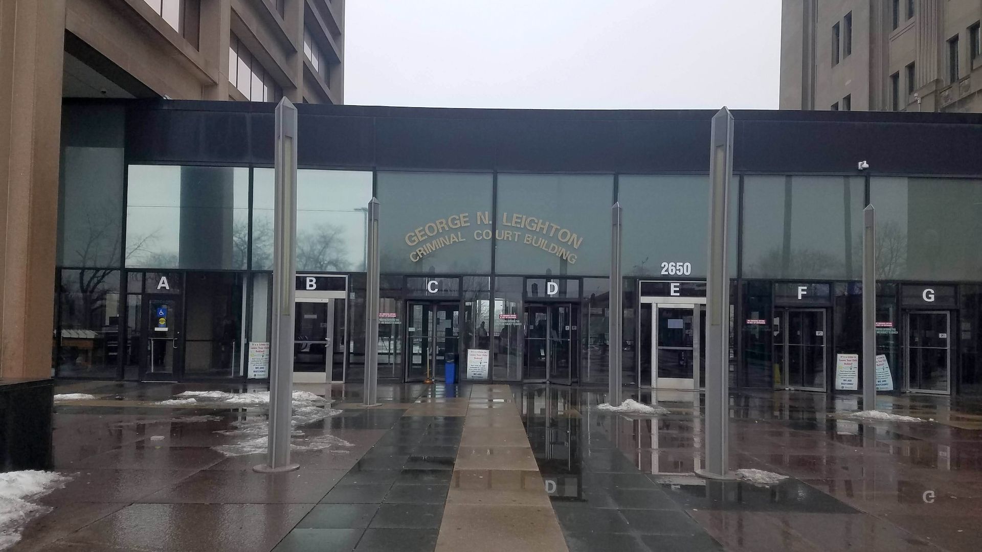 A drag front of a building with windows between two brown buildings