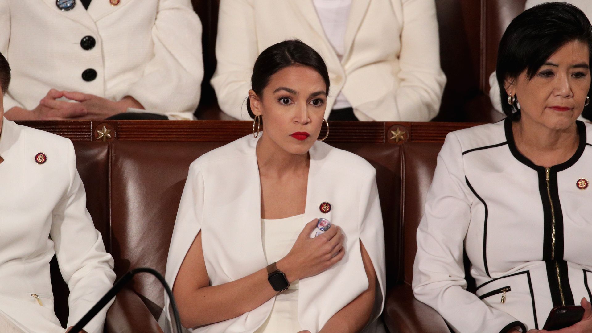 Alexandria Ocasio-cortez in white in the house chamber
