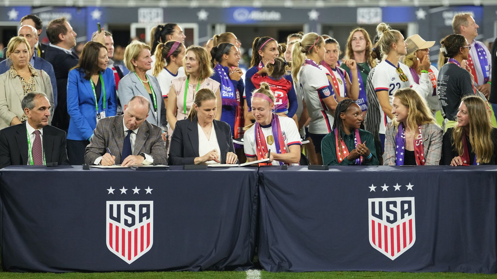 Becky Sauerbrunn #4 of the United States and US Soccer Federation president Cindy Parlow Cone sign the collective bargaining agreement.