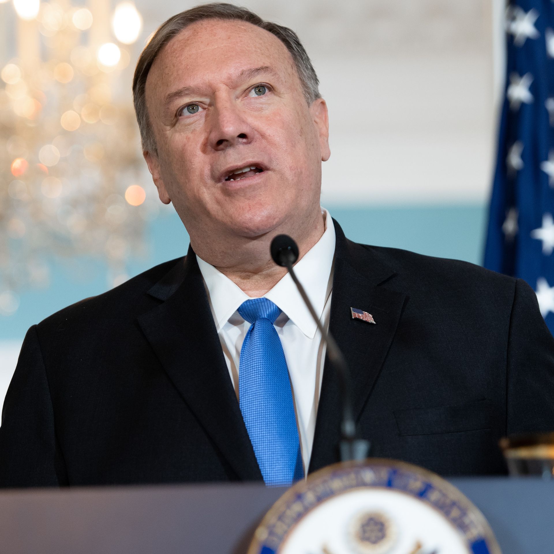 Mike Pompeo speaking at a lectern in front of an American flag