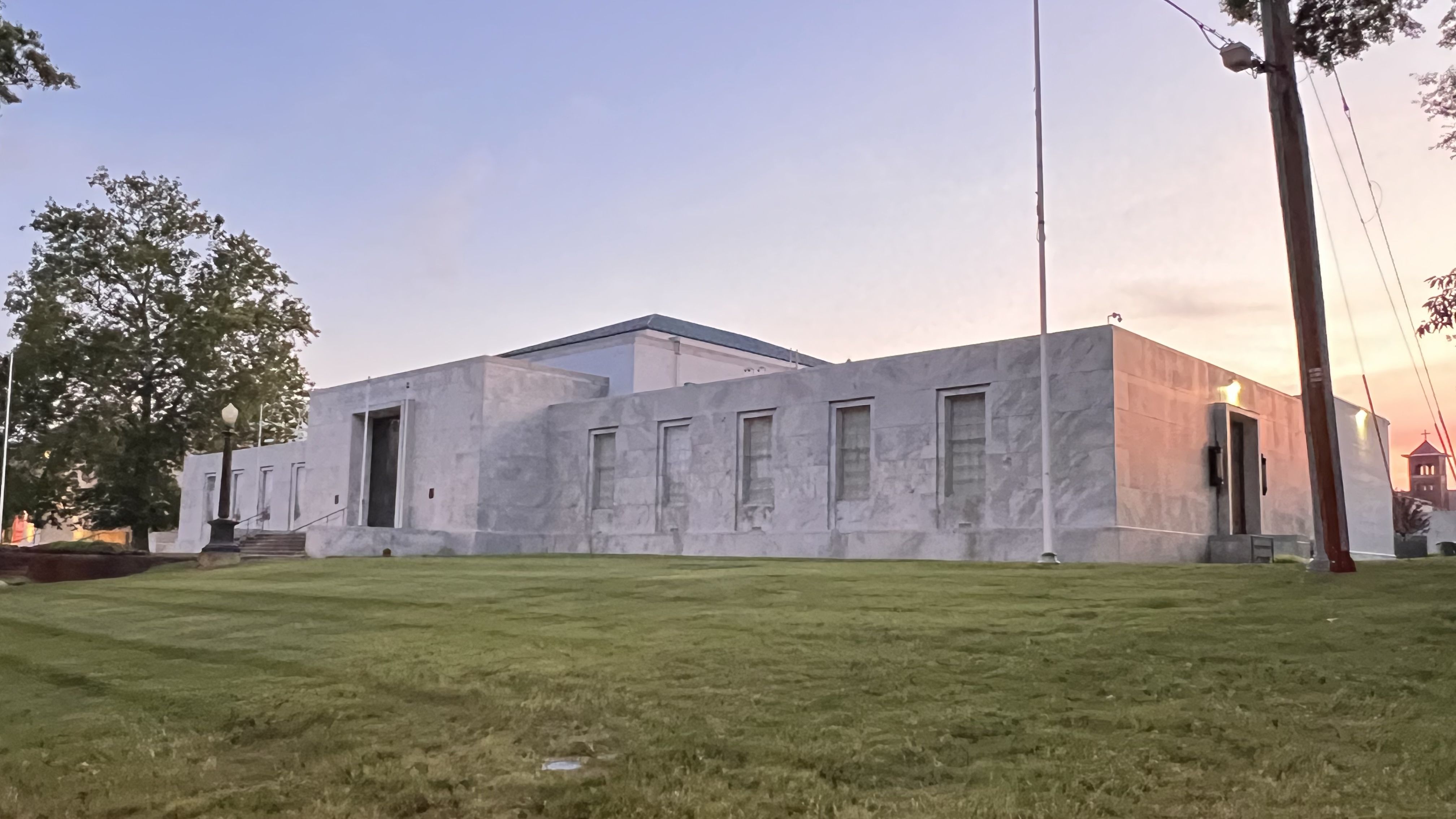 a building up on a hill. the sunset is in the back