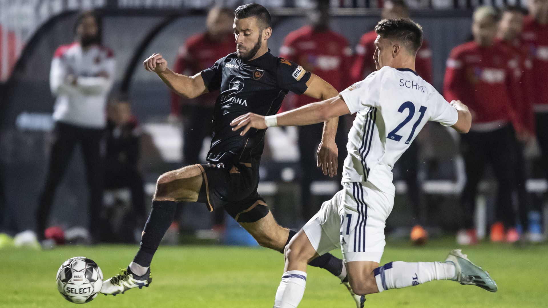 Two soccer players on a field.