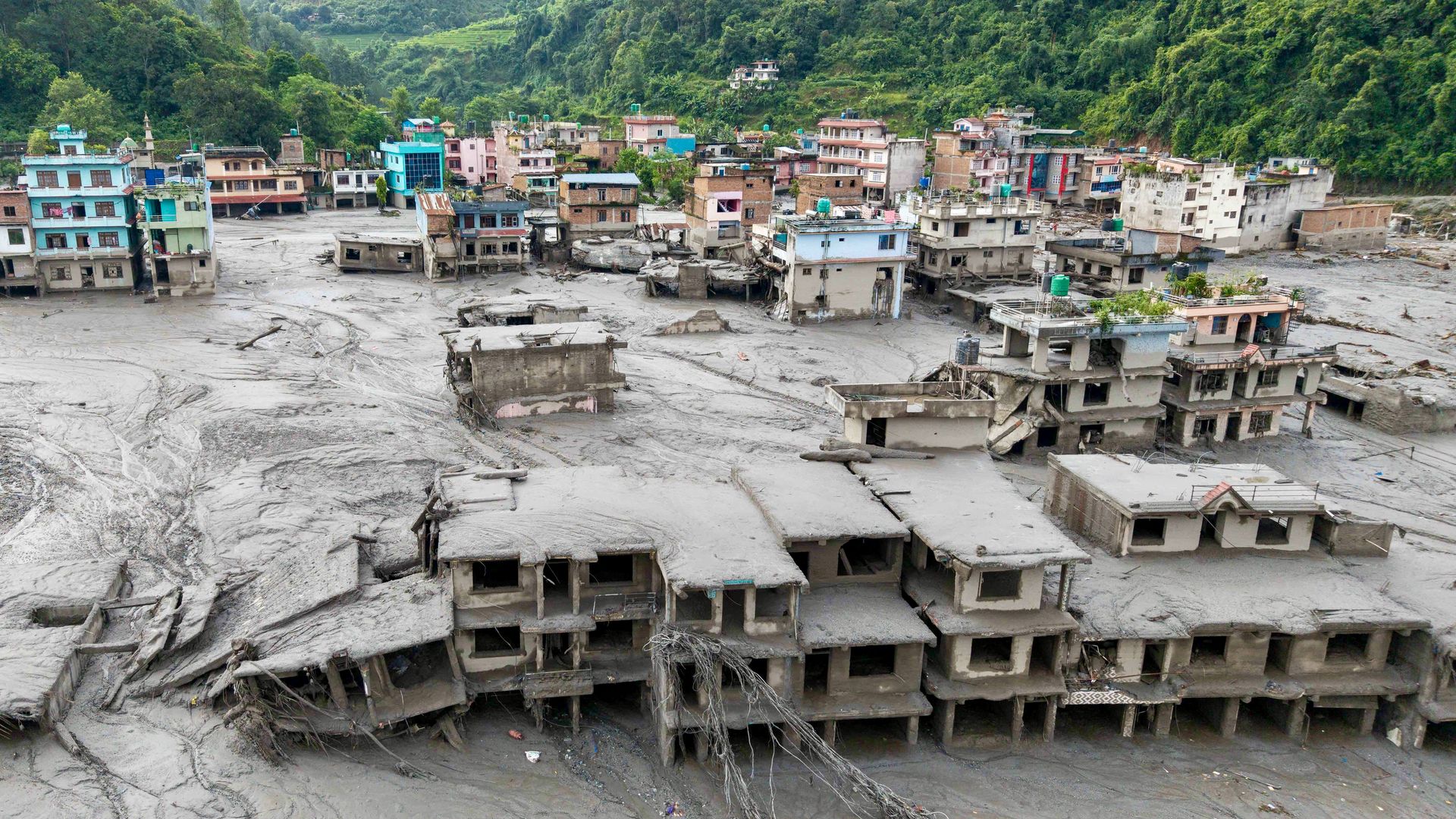 An aerial view shows houses lying deluged in sludge after flash floods in Nepal