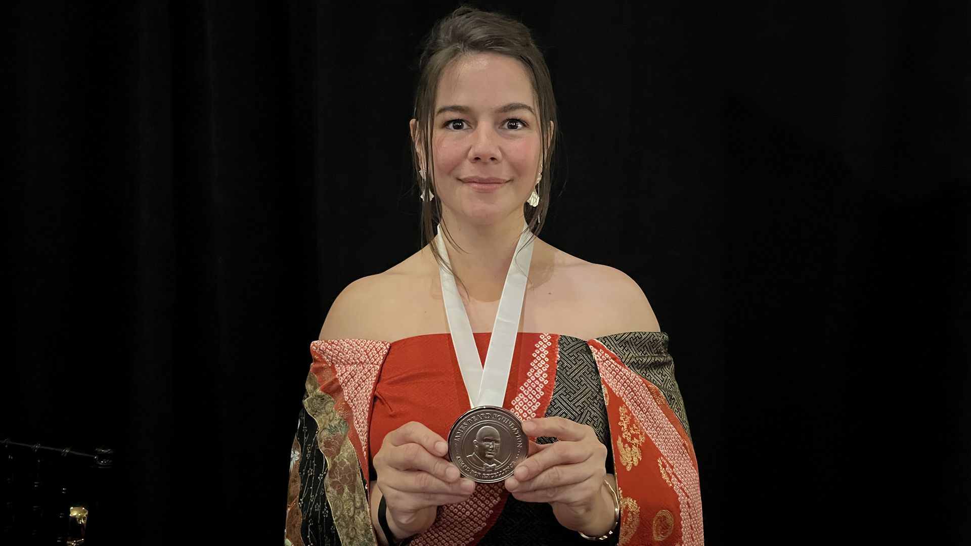 woman holding an award