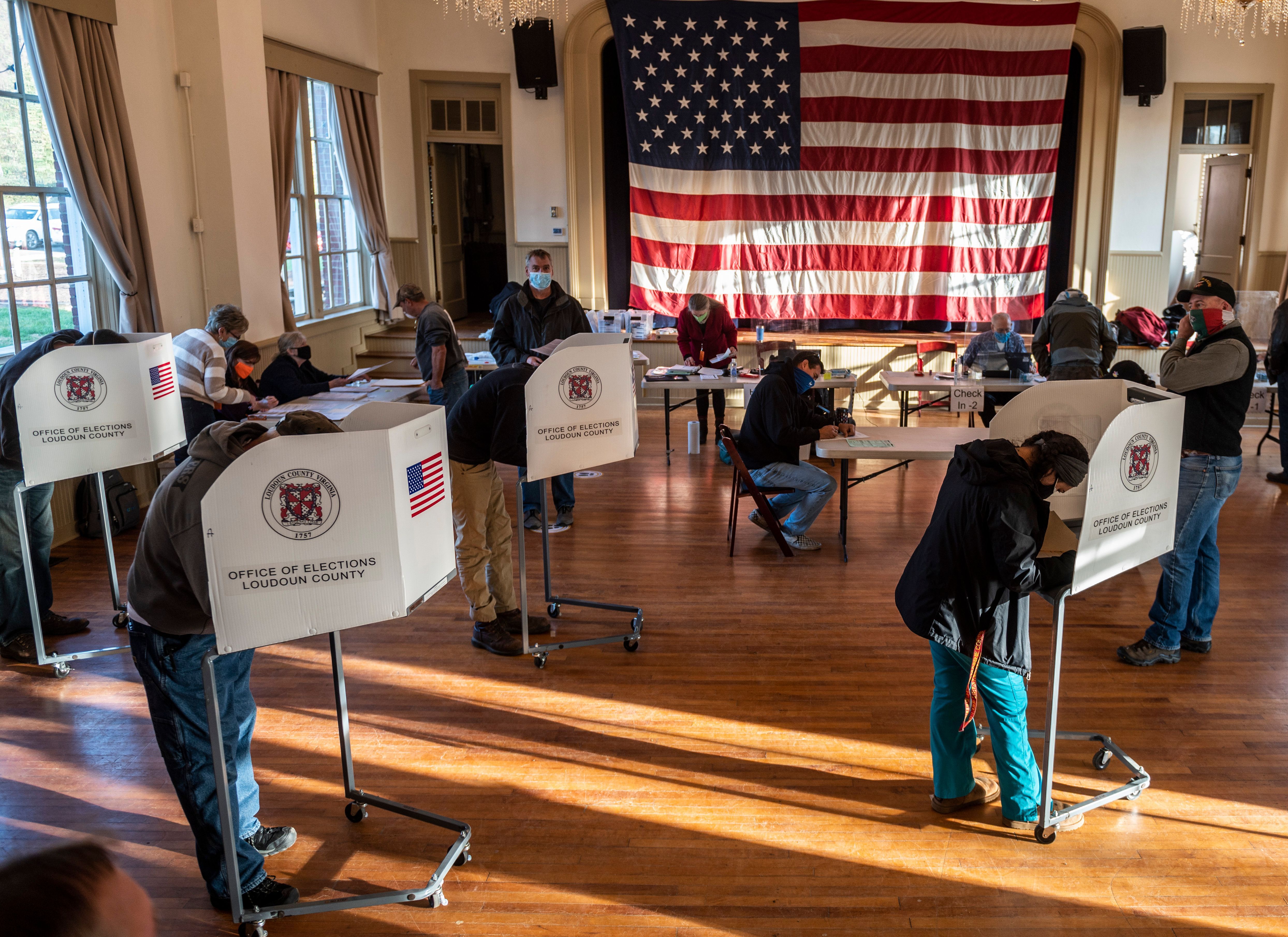  Voters cast their ballots at the old Stone School, used as a polling station, on election day in Hillsboro, Virginia on November 3,