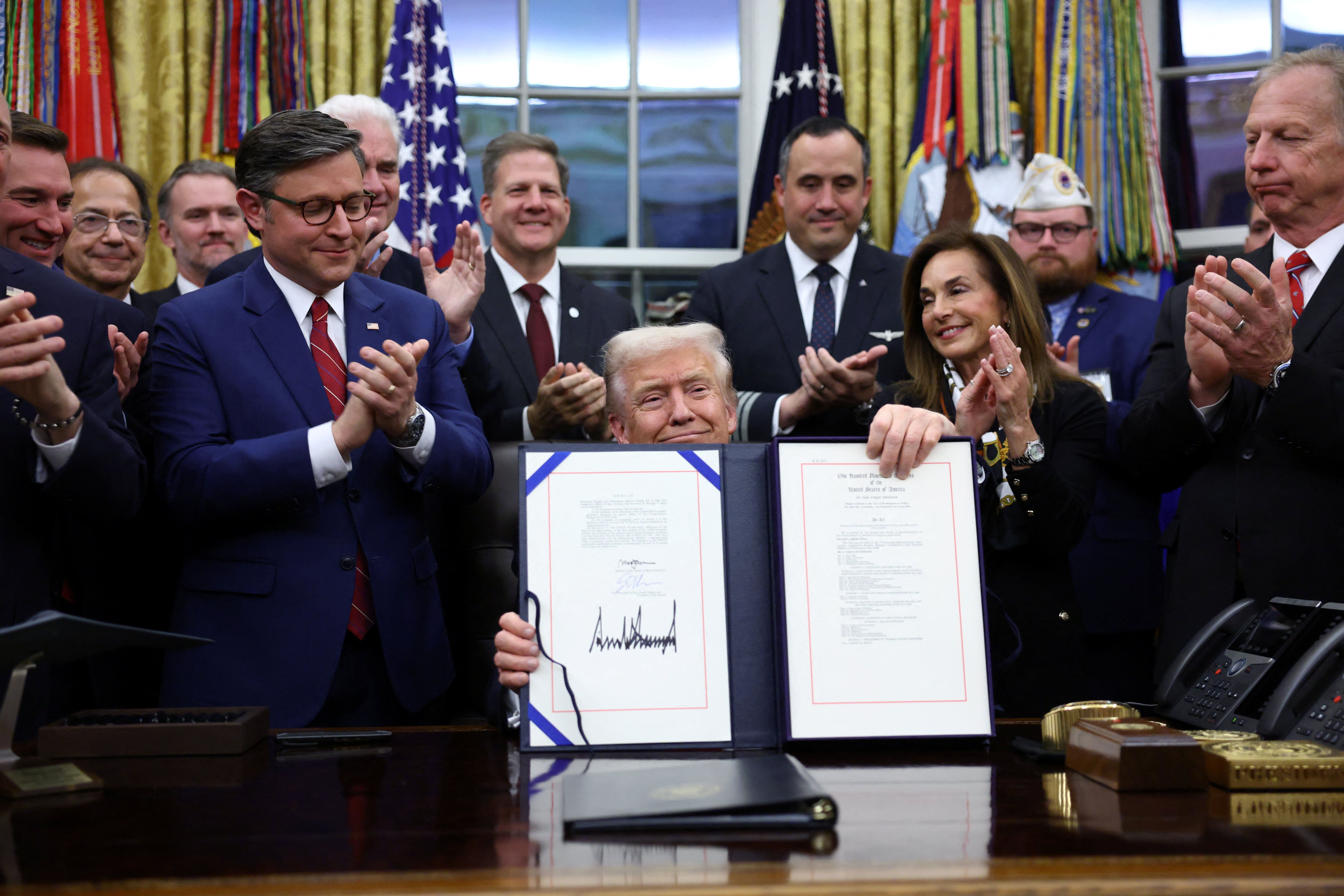 President Trump signs the funding bill to end the government shutdown in the Oval Office last night.