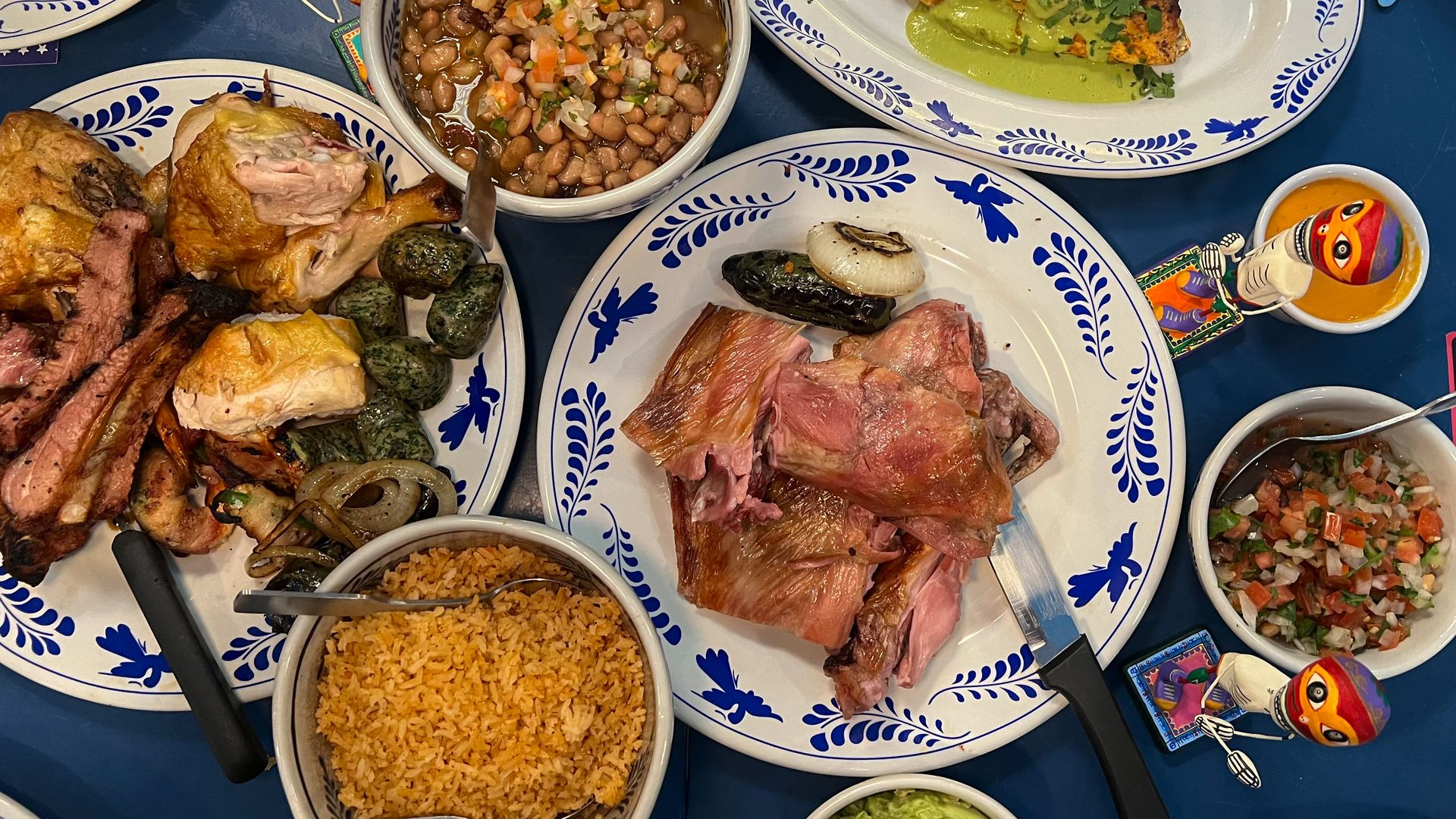 A spread of food with various meats and sides. 