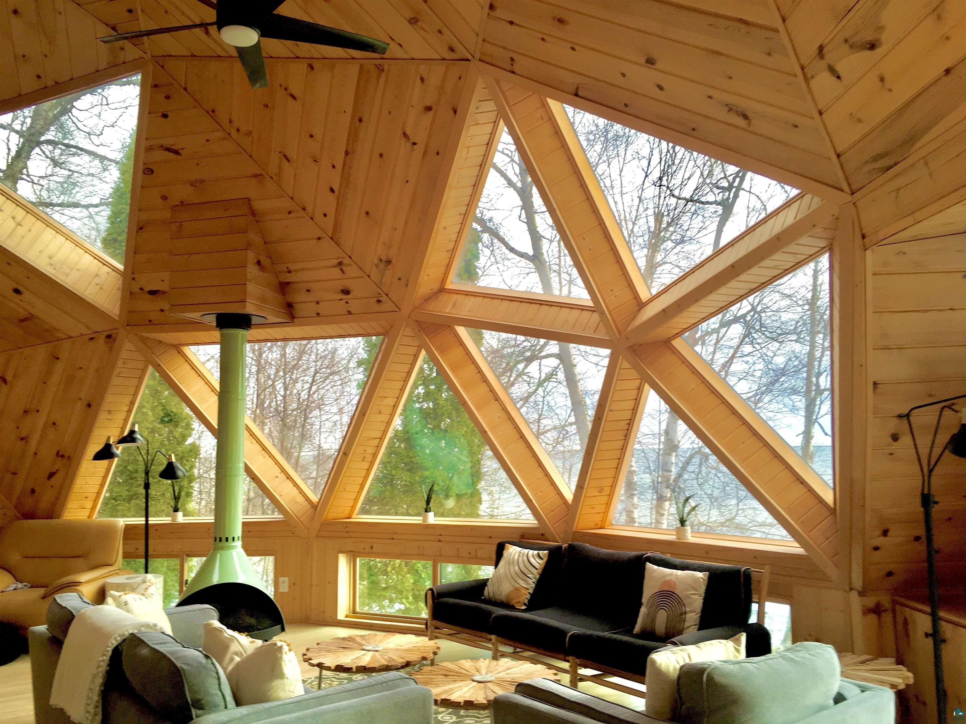 The inside of a dome home with large triangle windows.