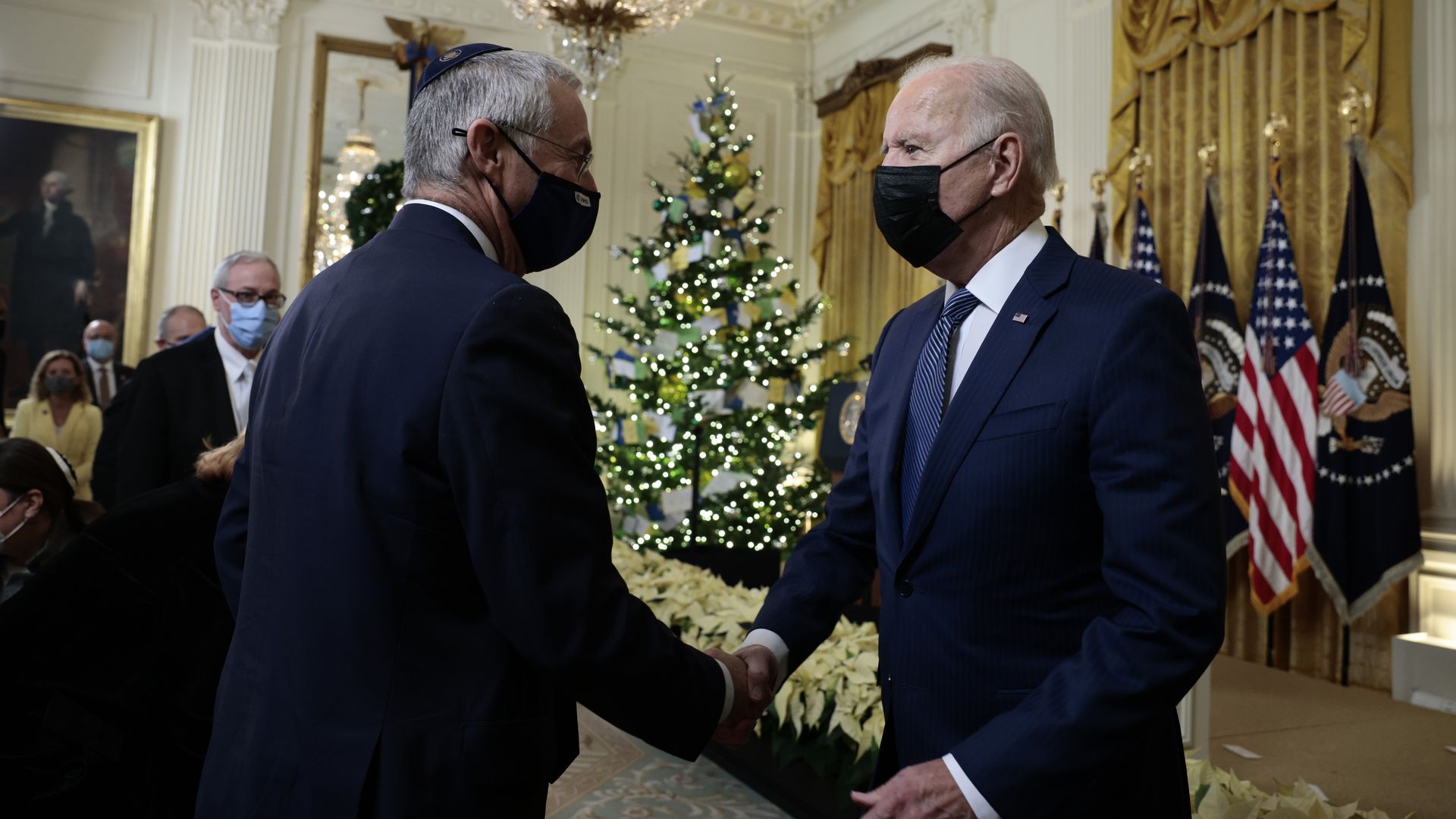 Biden shakes hands with Michael Herzog, the Israeli Ambassador to the United States after menorah lighting ceremony in celebration of Hanukkah in the East Room of the White House on December 01, 2021