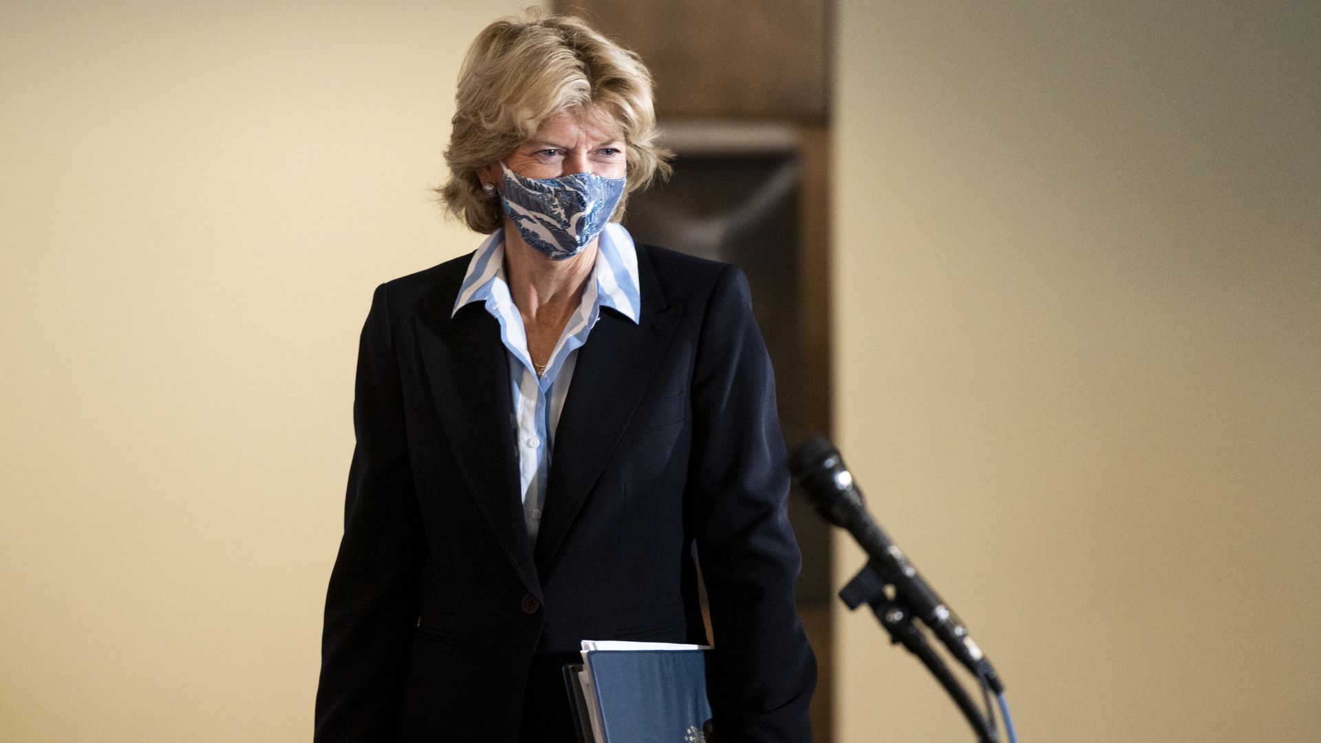 Lisa Murkowski wears a face mask and a suit