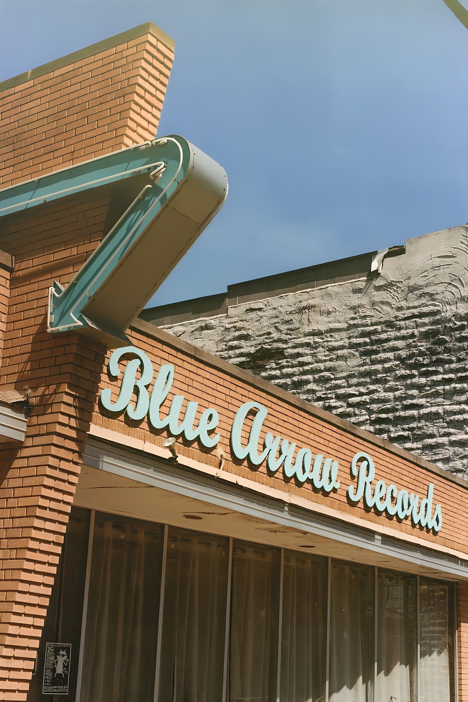 Photo of a record store front called Blue Arrow Records.