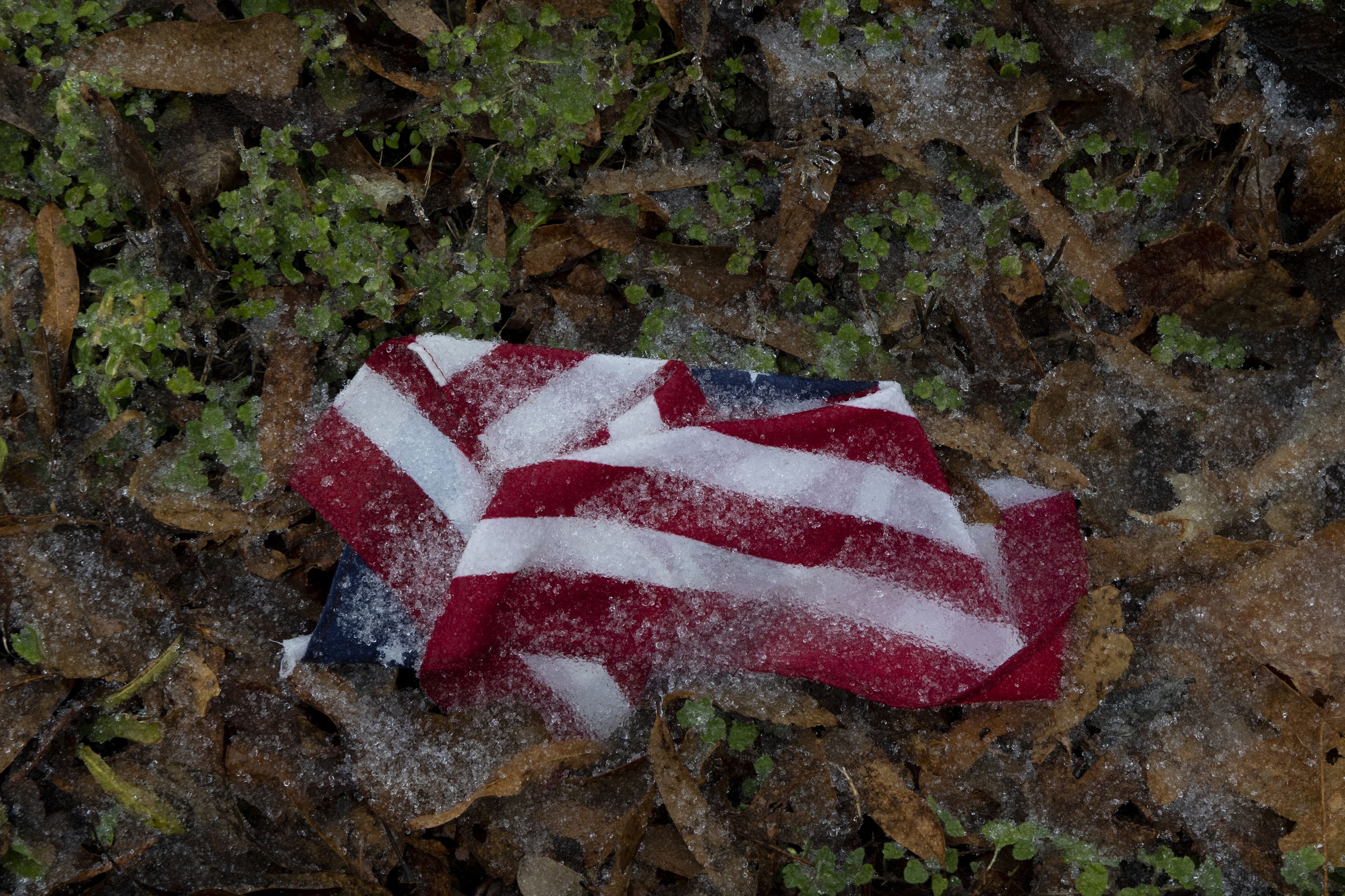  Ice begins to accumulate on a crumpled American flag
