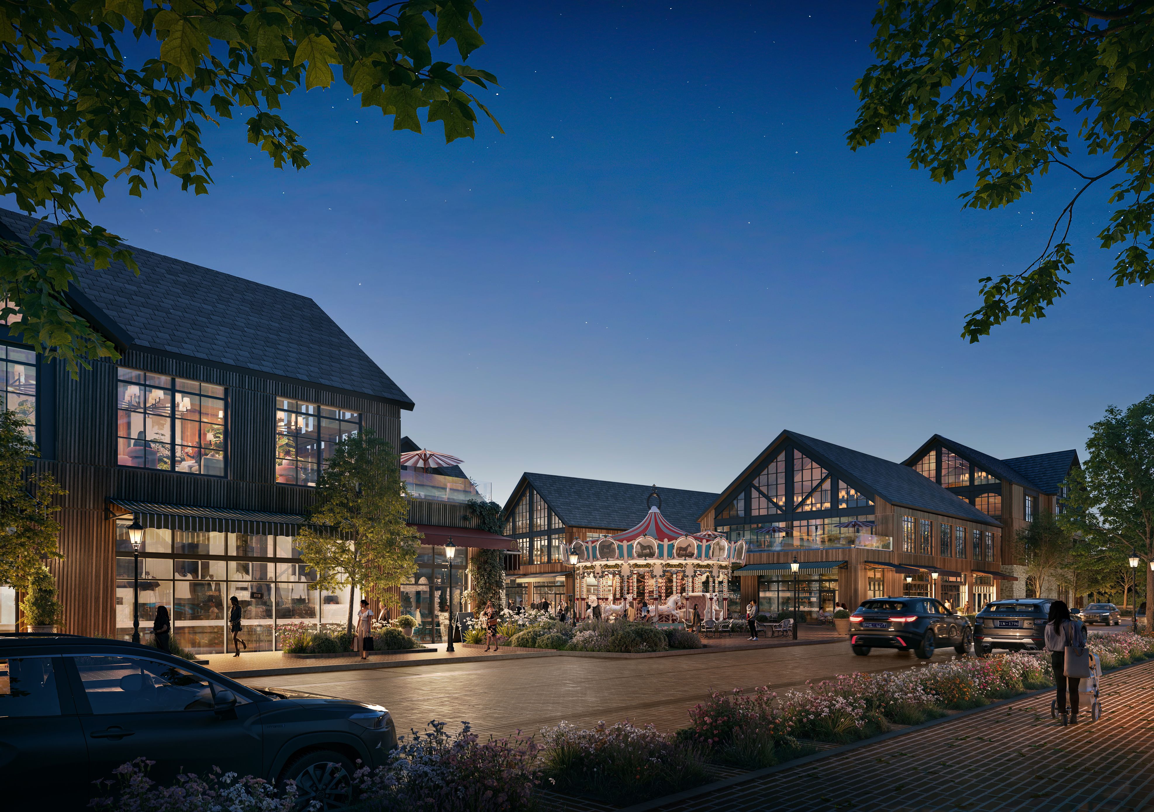 Evening scene of a modern village with wooden buildings, a lit carousel center, cars on a street, people walking, and trees under a clear starry sky.