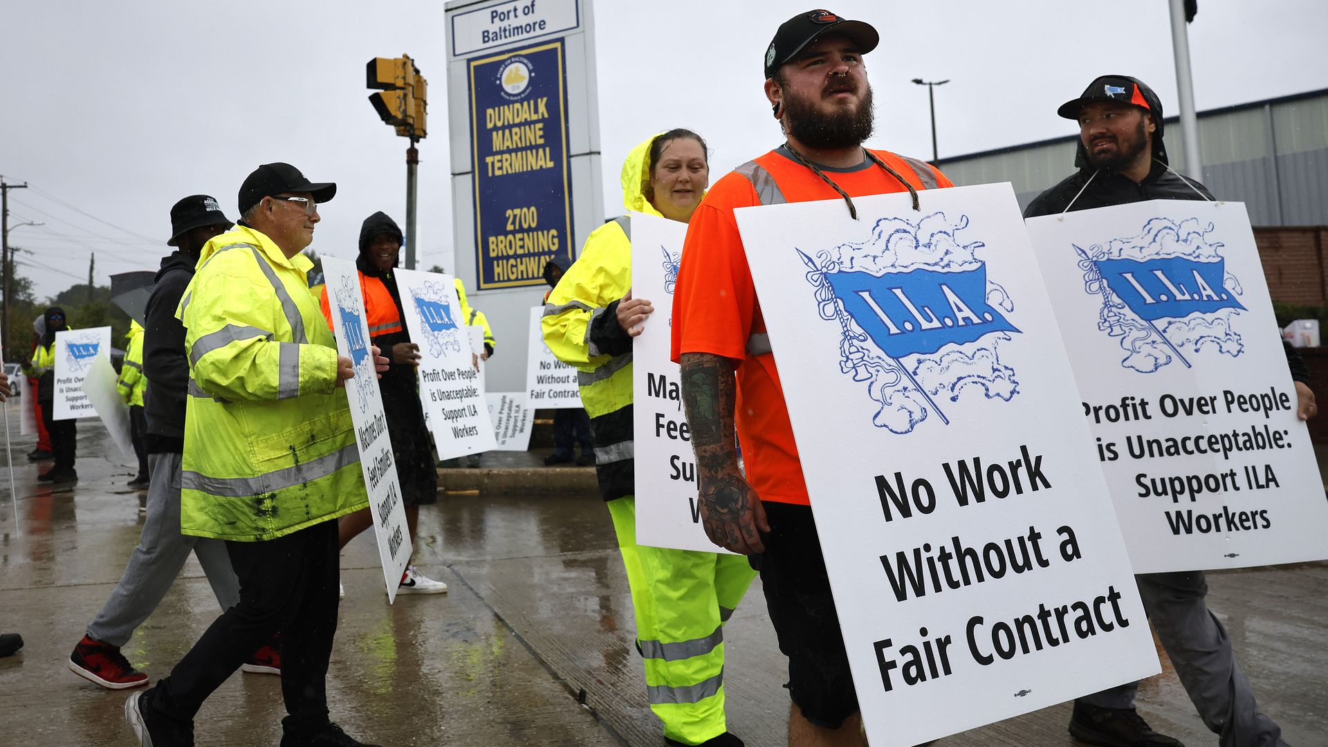 A photo of protestors holding signs calling for fair wages.