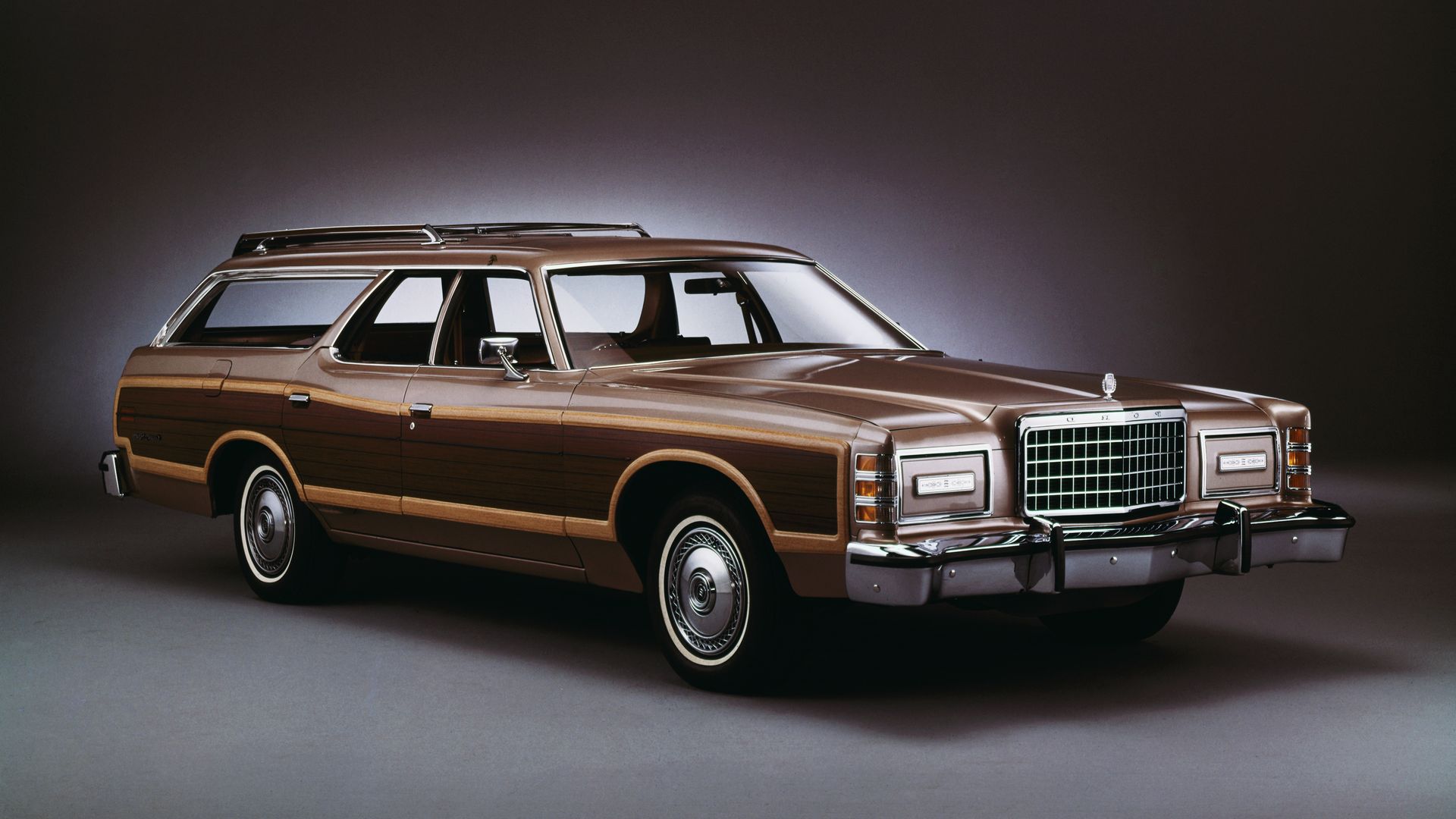 Image of a brown 1978 Ford Country Squire station wagon, with wood paneling on the side. 