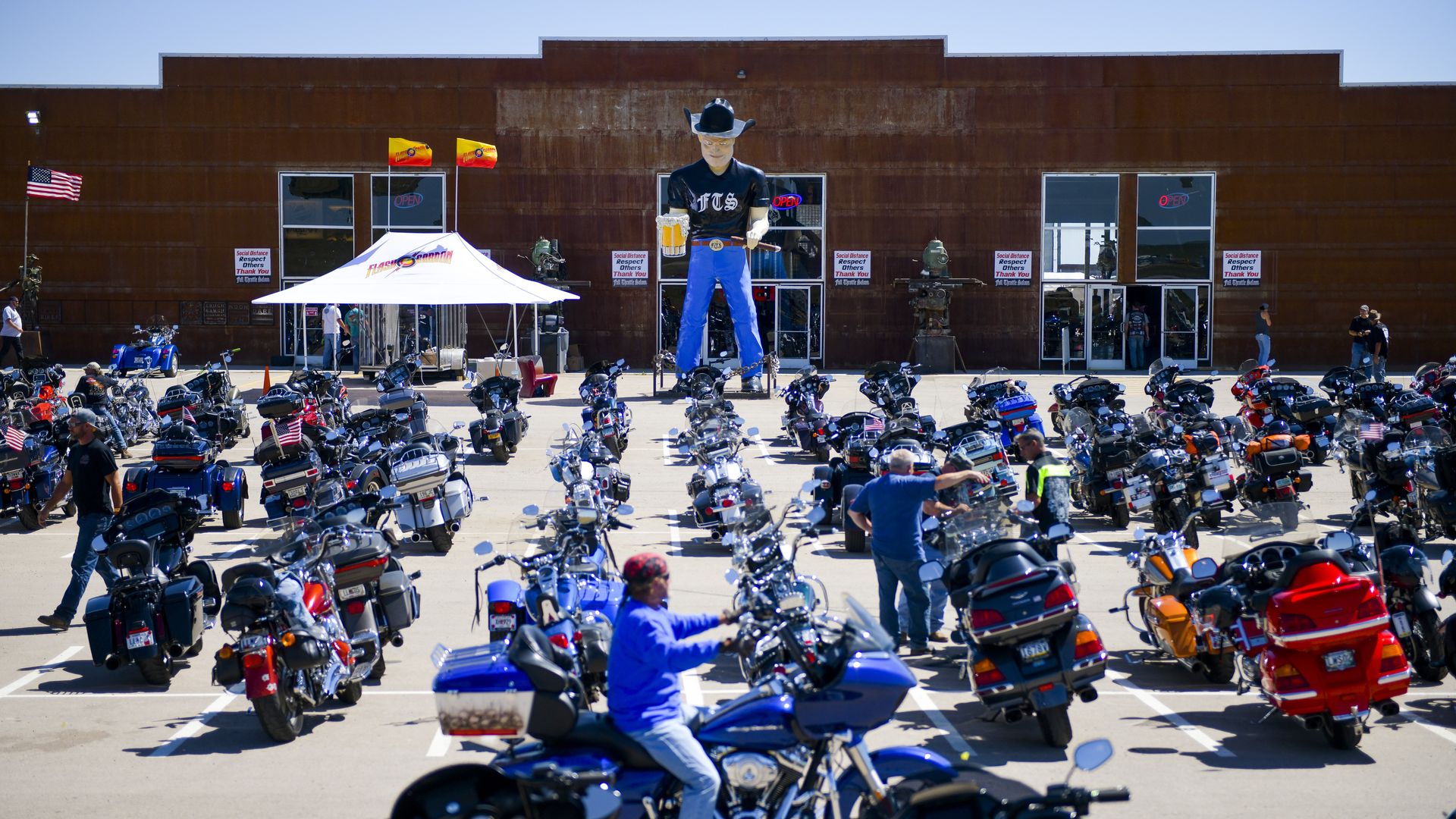 A motorcycle rider looks for parking outside the Full Throttle Saloon during the 80th Annual Sturgis Motorcycle Rally in Sturgis, South Dakota on August 9,