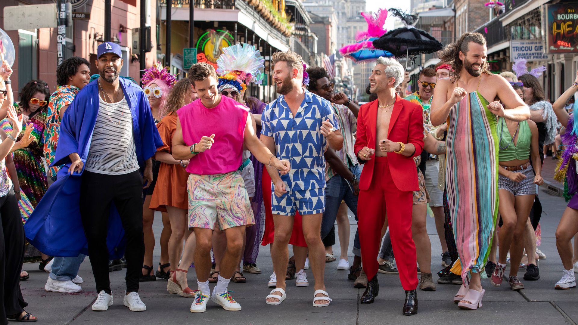 The Queer Eye cast dances with a crowd on a busy Bourbon Street