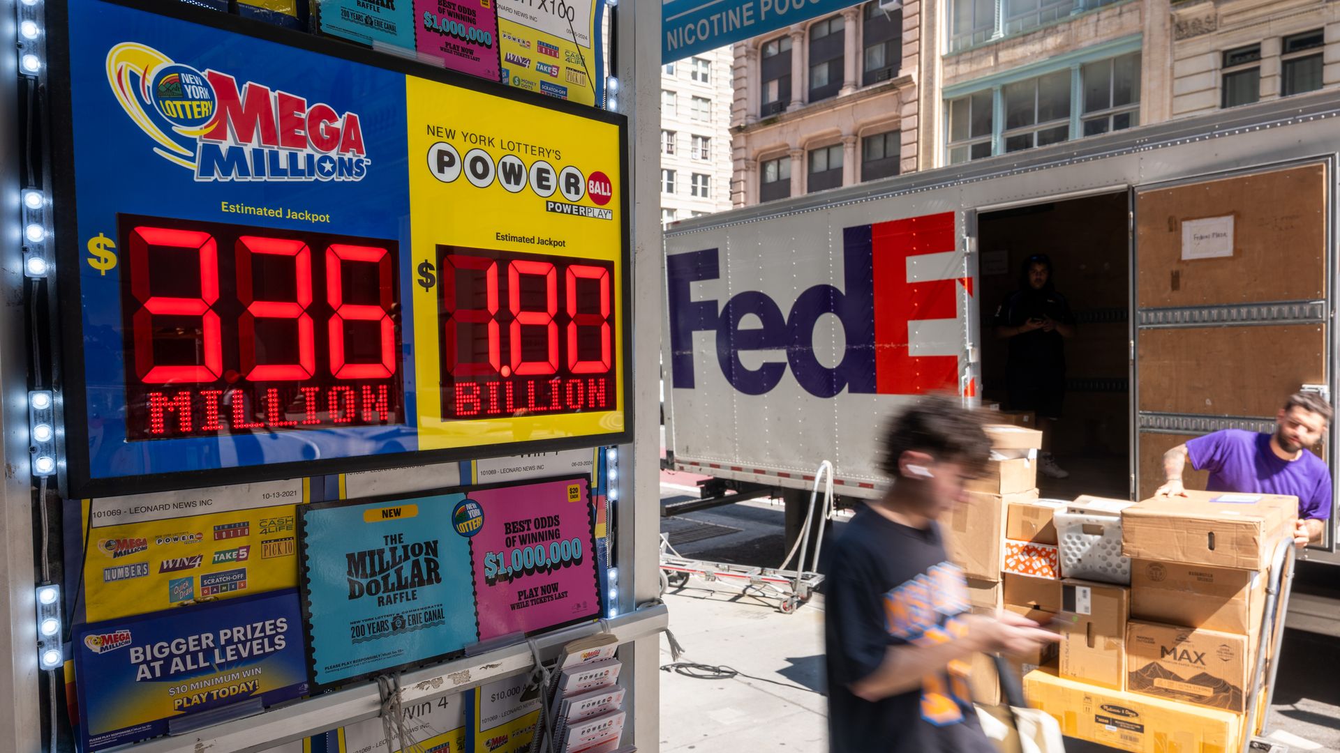 A newsstand in Manhattan advertises the latest Powerball Jackpot, now reaching $1.8 billion, on digital signs. 