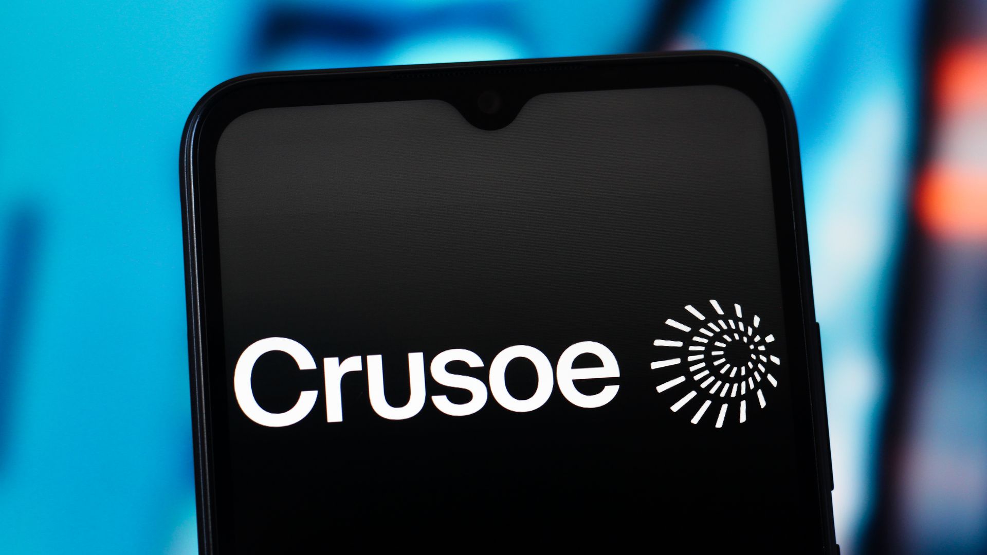The logo for data center company Crusoe is displayed in white against the black background of a smartphone screen.