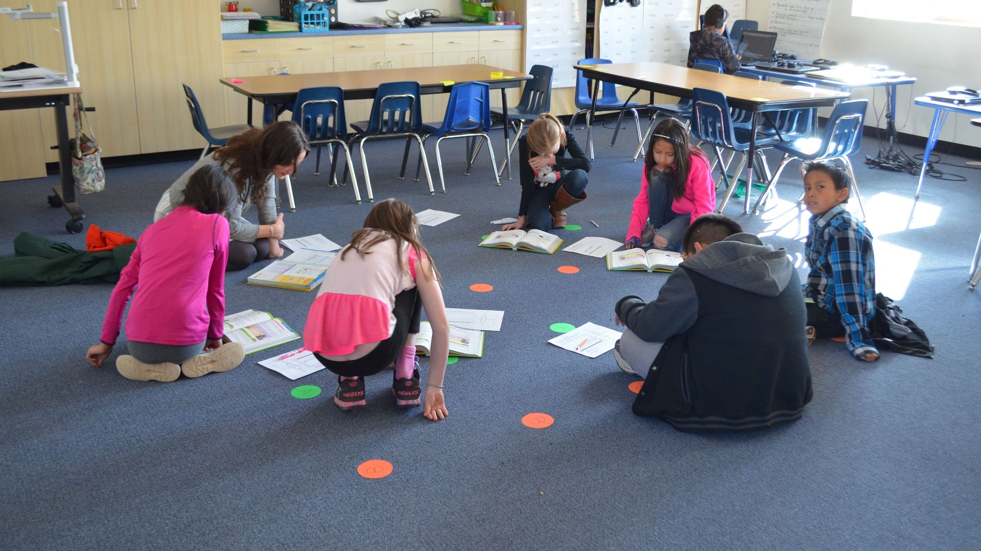 Picture of students sitting in a circle in a classroom