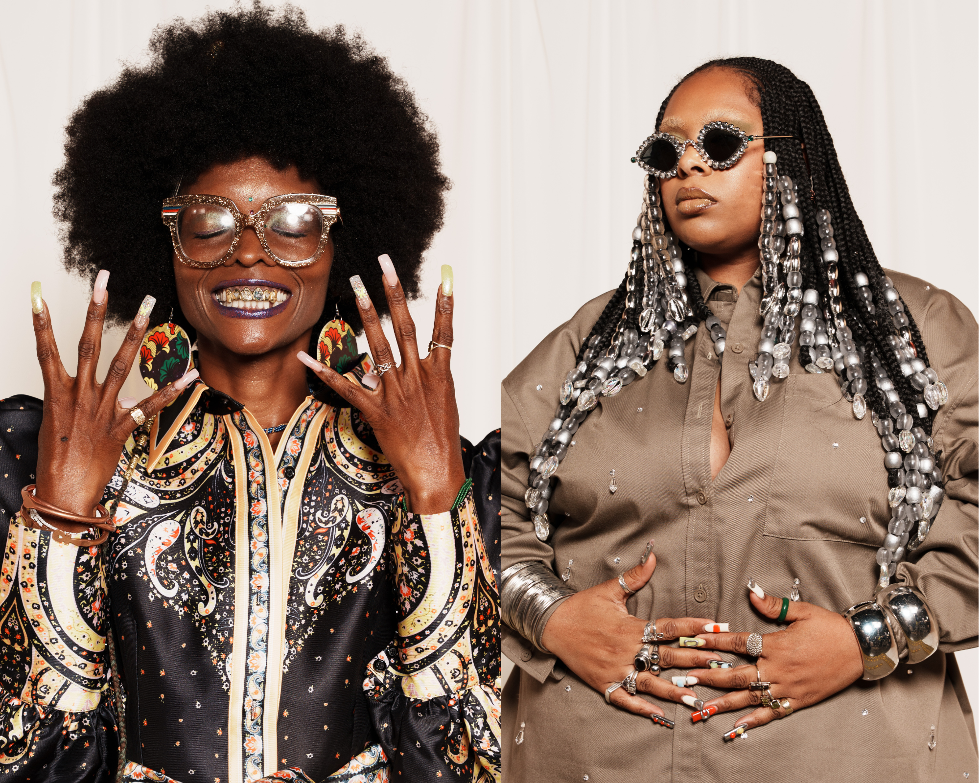 Two stylish Black women posing; left one with large afro, oversized glasses, patterned blouse, and long nails; right one with long braided hair with beads, sunglasses, brown shirt, and decorated nails.