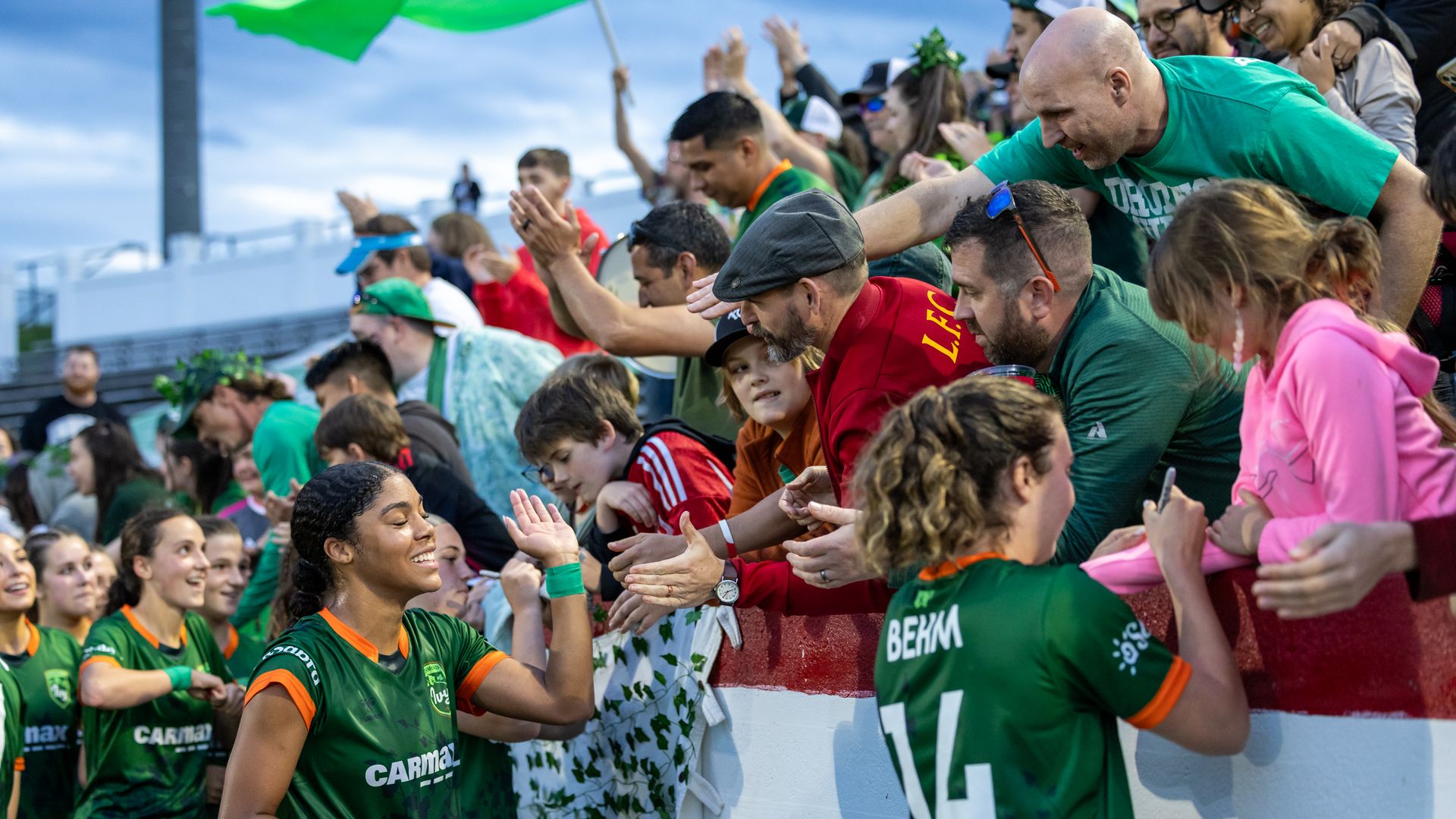 Richmond ivy players signing autographs after a game