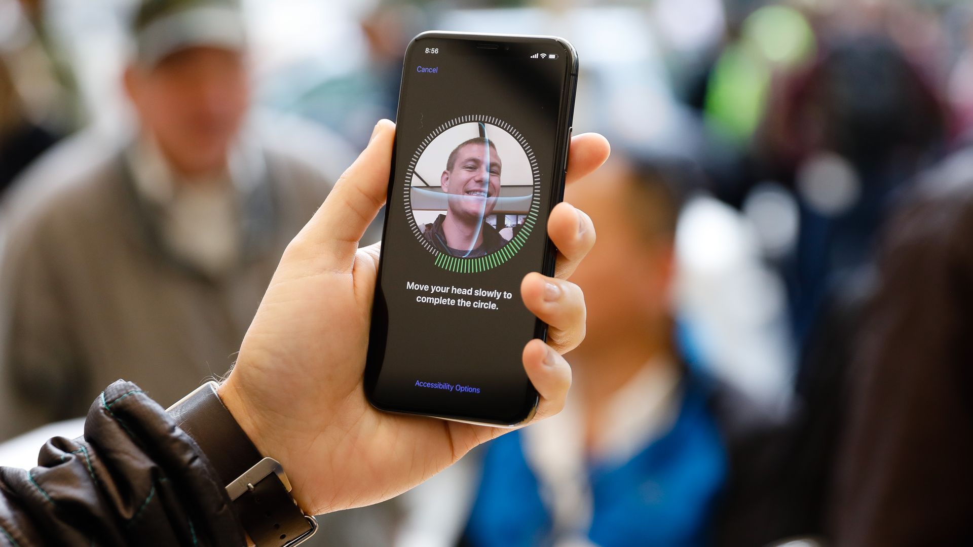 A man uses facial recognition on an iPhone