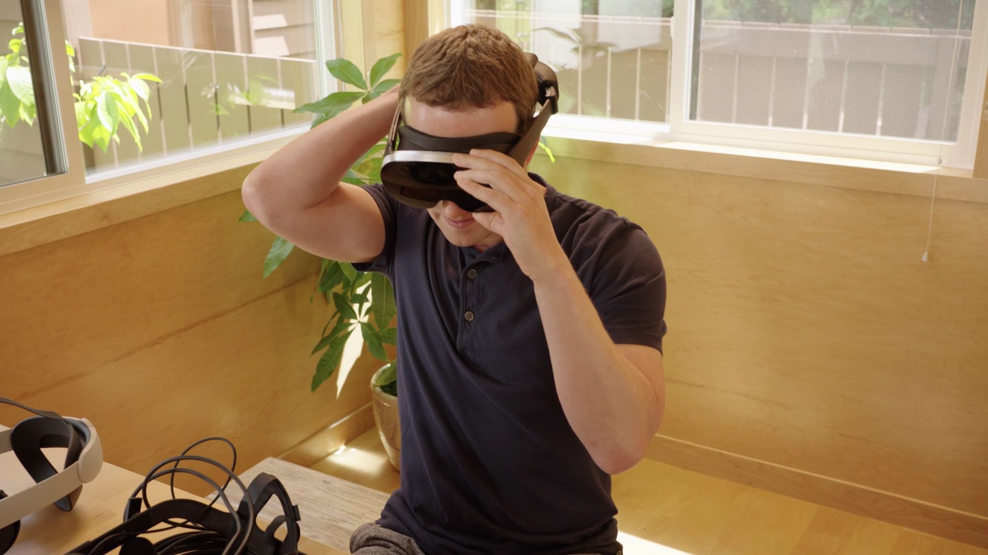 Meta CEO Mark Zuckerberg tries on the company's Holocake 2 prototype headset.