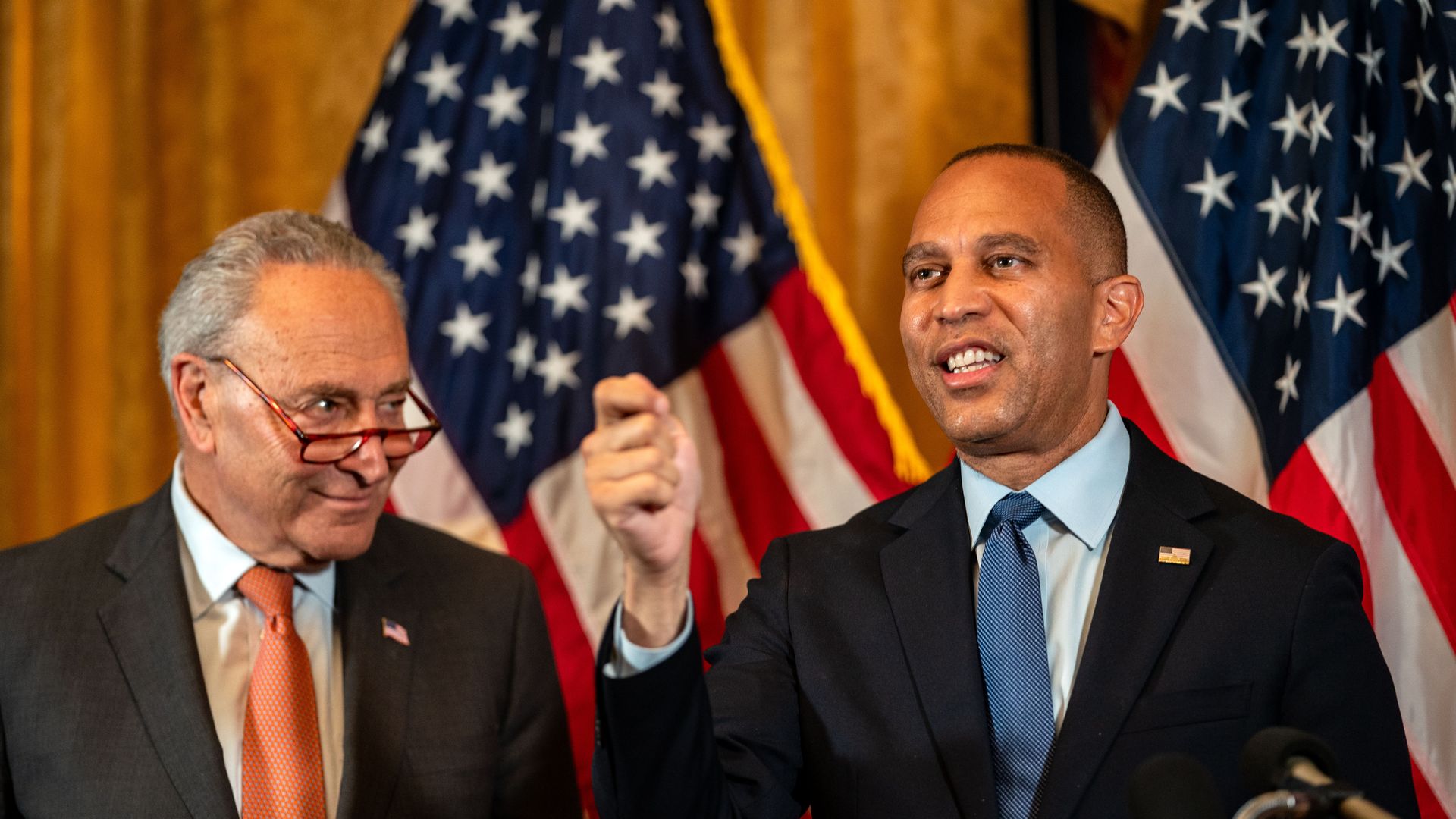 Sen. Chuck Schumer and Rep. Hakeem Jeffries in front of American flags