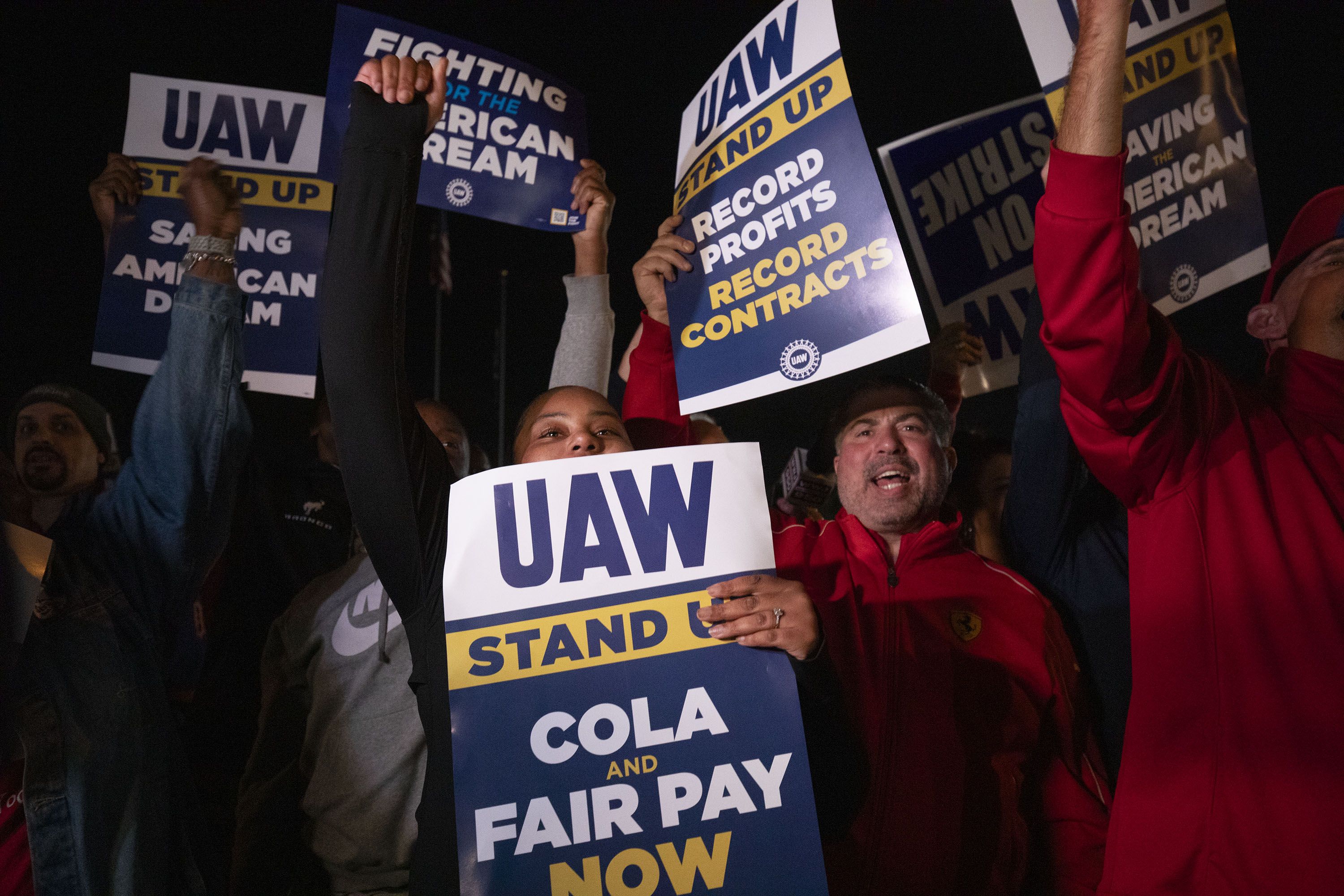 UAW members cheering with signs at a Ford assembly plant in Wayne, Michigan, on Sept. 15.