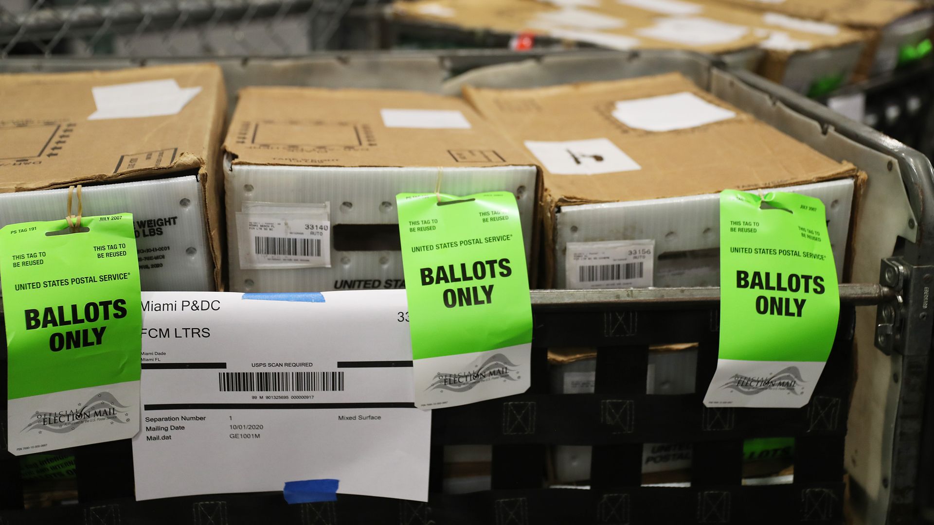 Boxes with ballots are seen at the Miami-Dade County Election Department as the vote-by-mail ballots are placed on to a U.S. Post Office truck to be delivered to voters