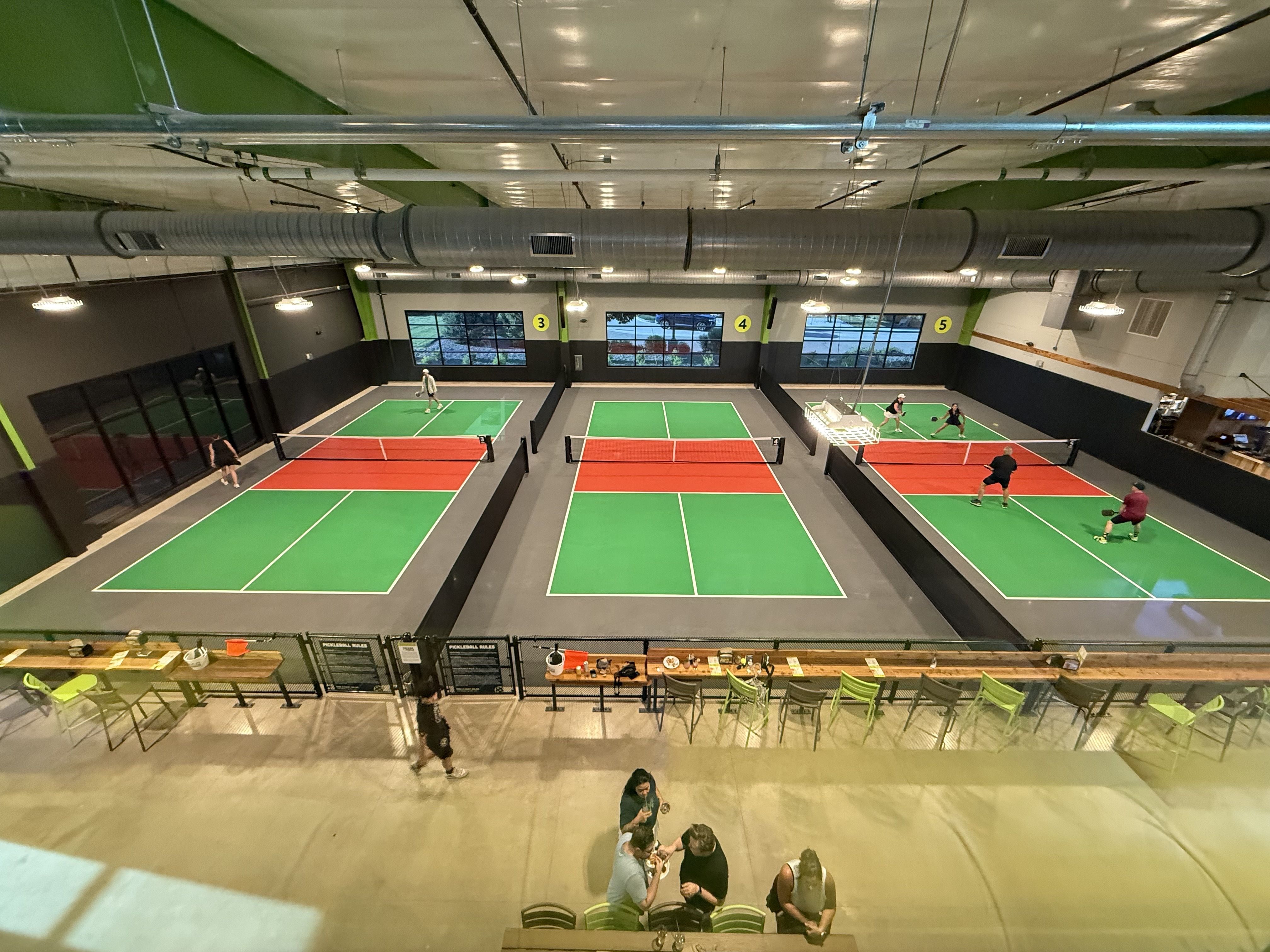 Multiple indoor pickleball courts.