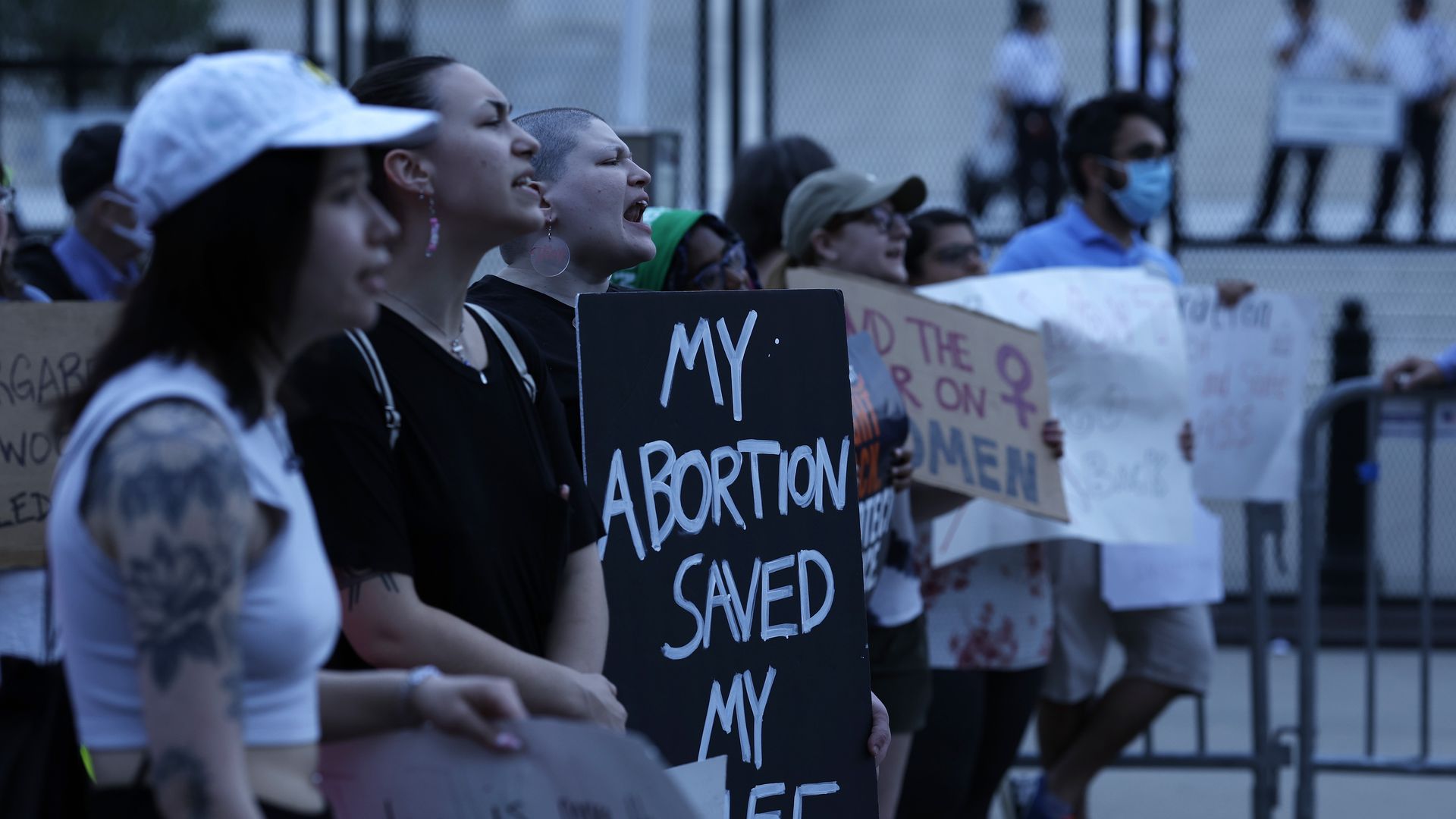 Photo of abortion rights protesters holding signs that say "My abortion saved my life"