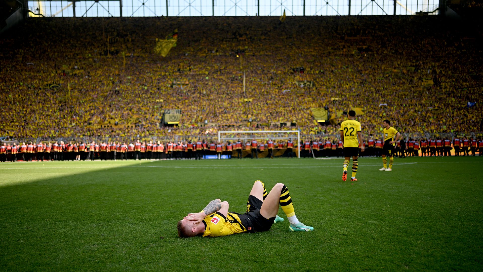 dortmund player on the ground head in hands