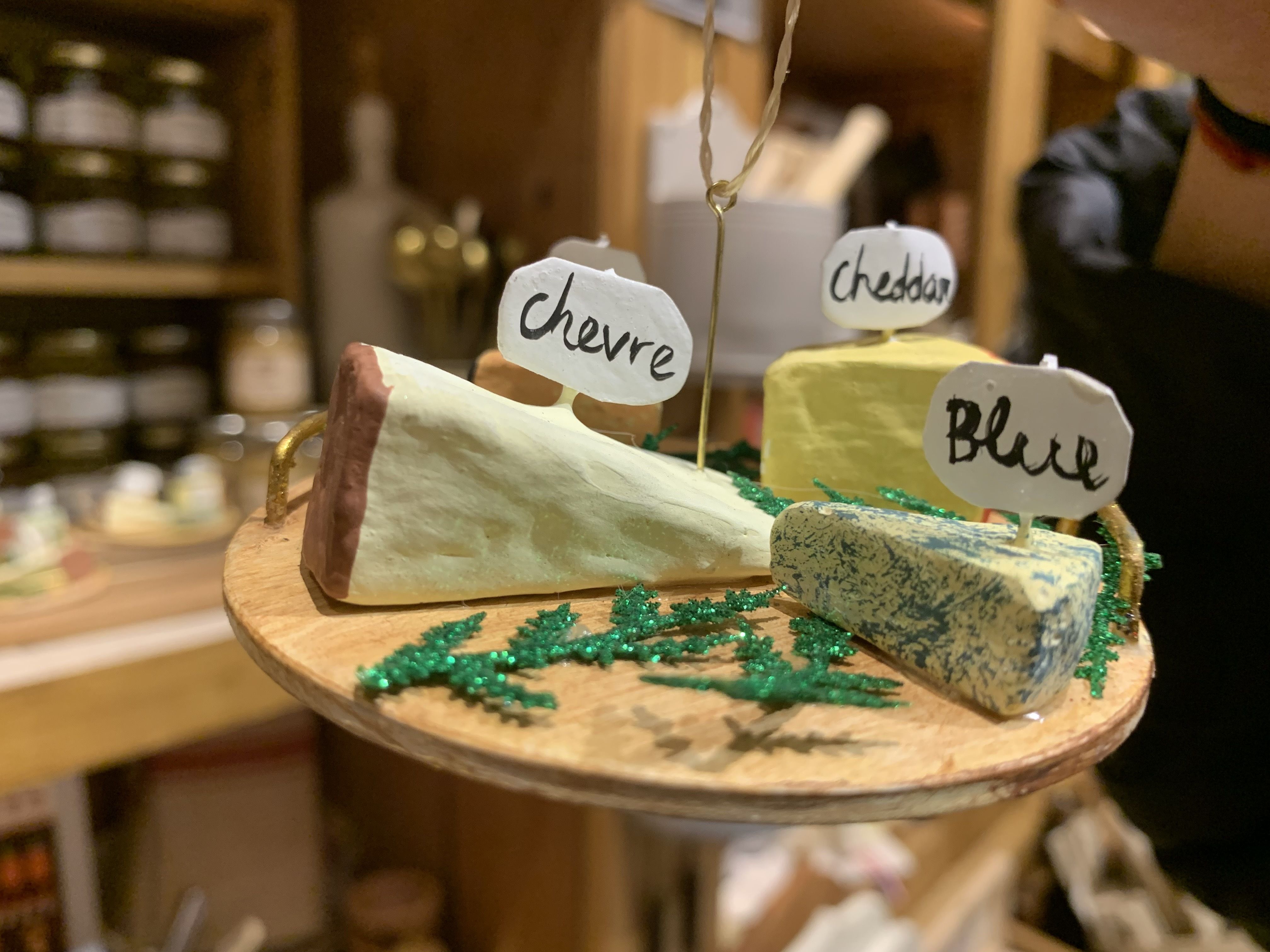 Photo of a Christmas tree ornament of fake slices of cheese on a plate 