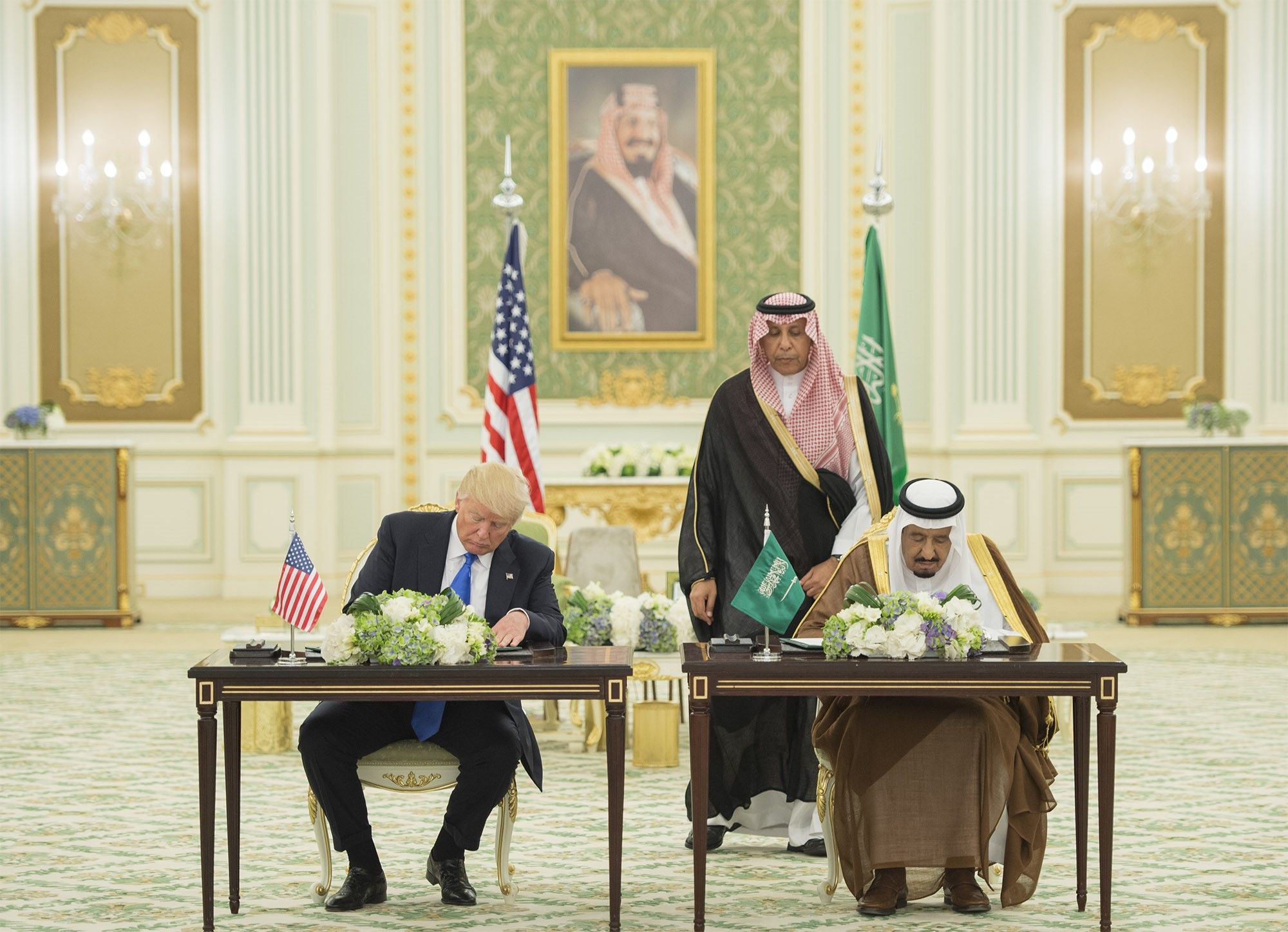 President Trump and Saudi King Salman sign agreements during Trump's 2017 visit. 
