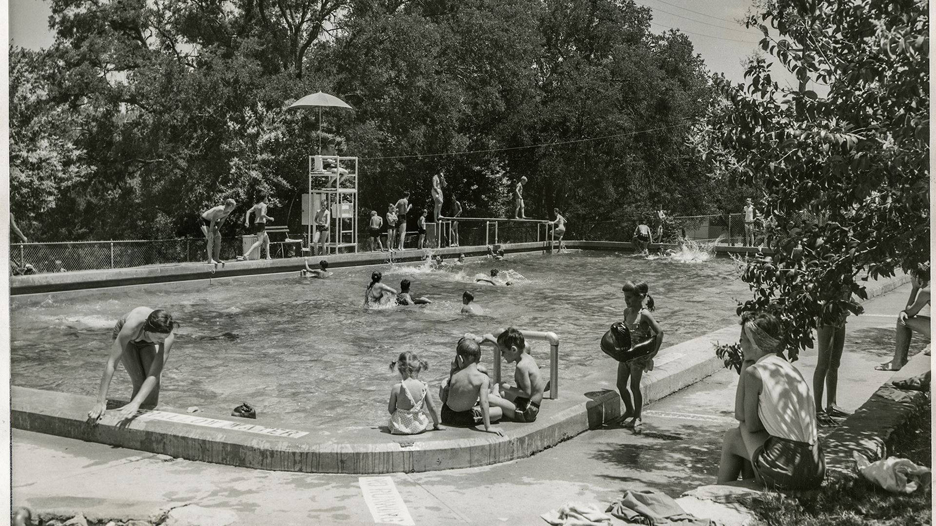 An old picture of people playing at Stacy Pool.