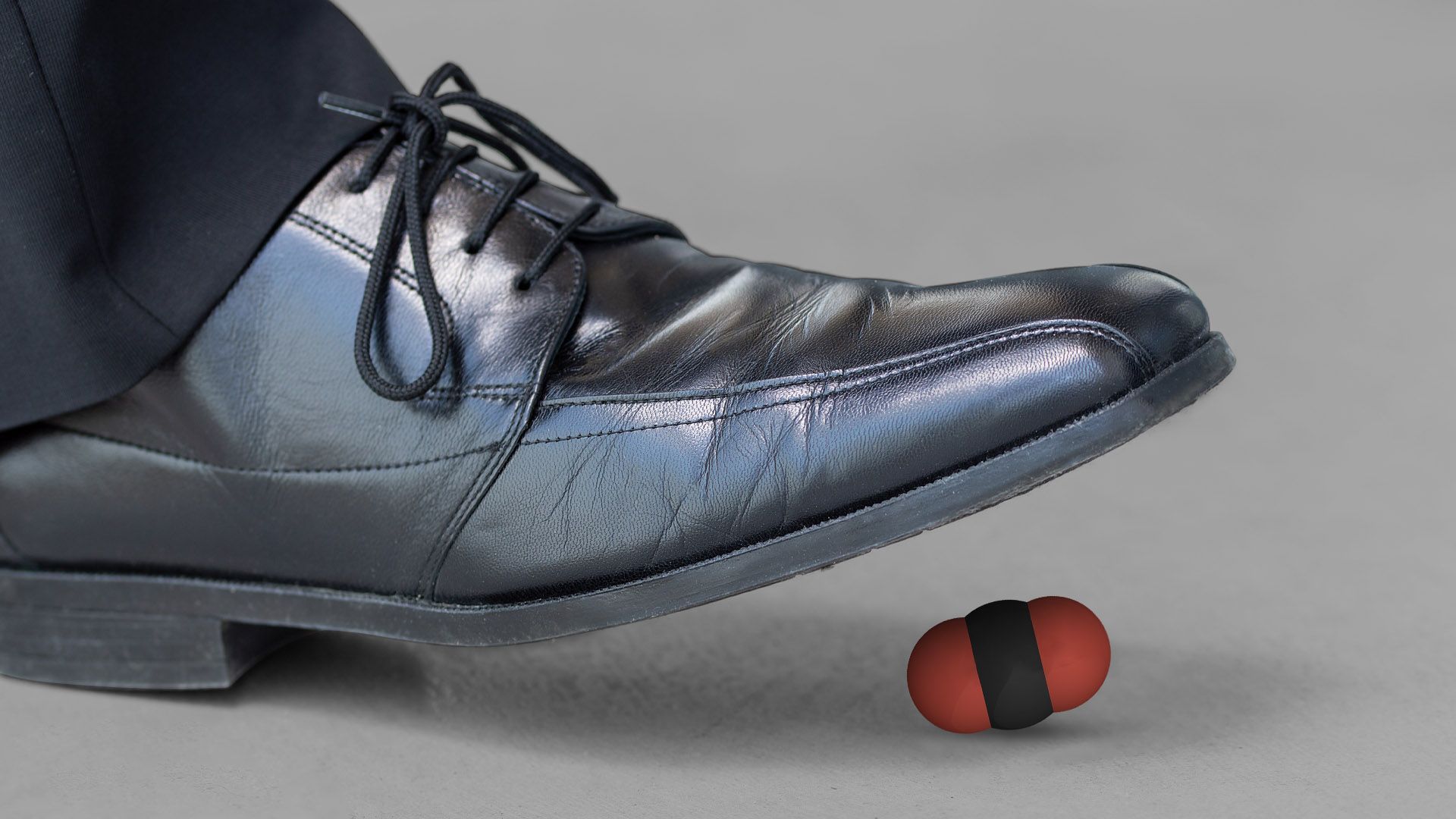 Illustration of a shoe stepping on a carbon molecule