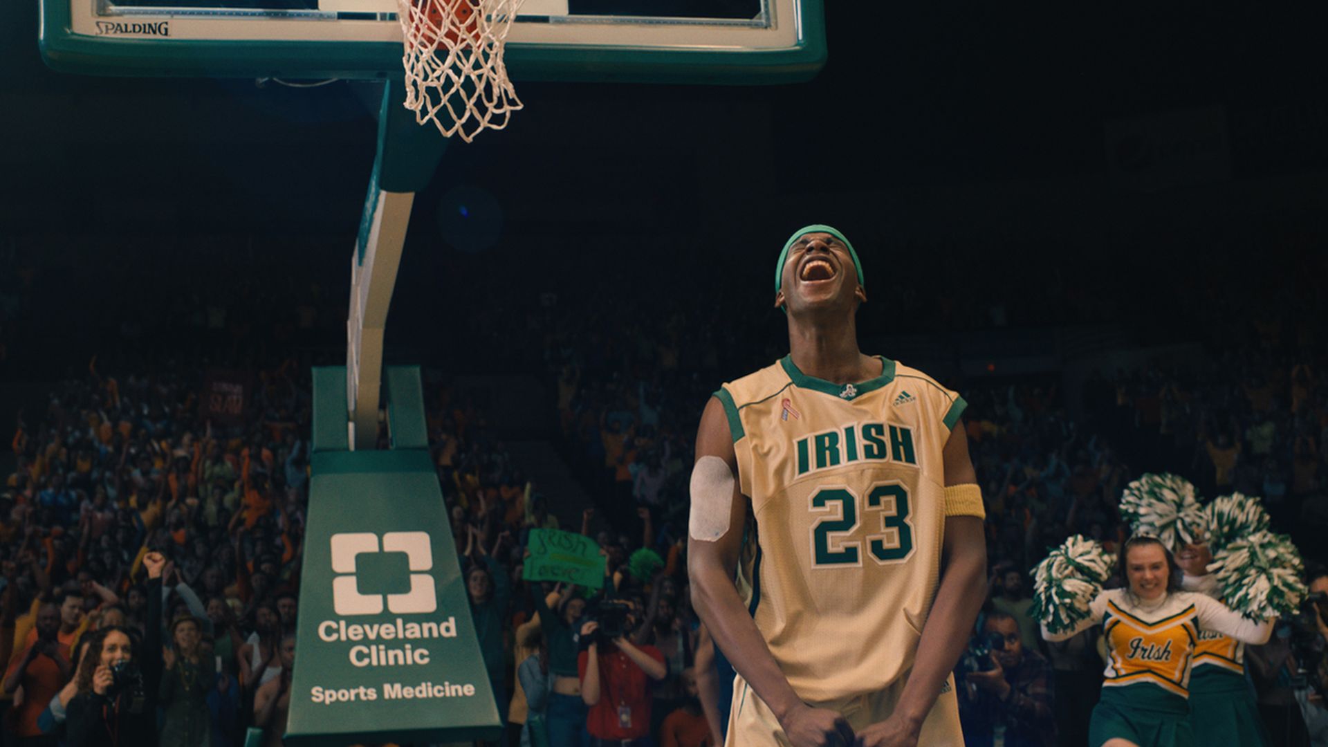 Marquis “Mookie” Cook as LeBron James in the Peacock series Shooting Stars, celebrating under a basketball hoop
